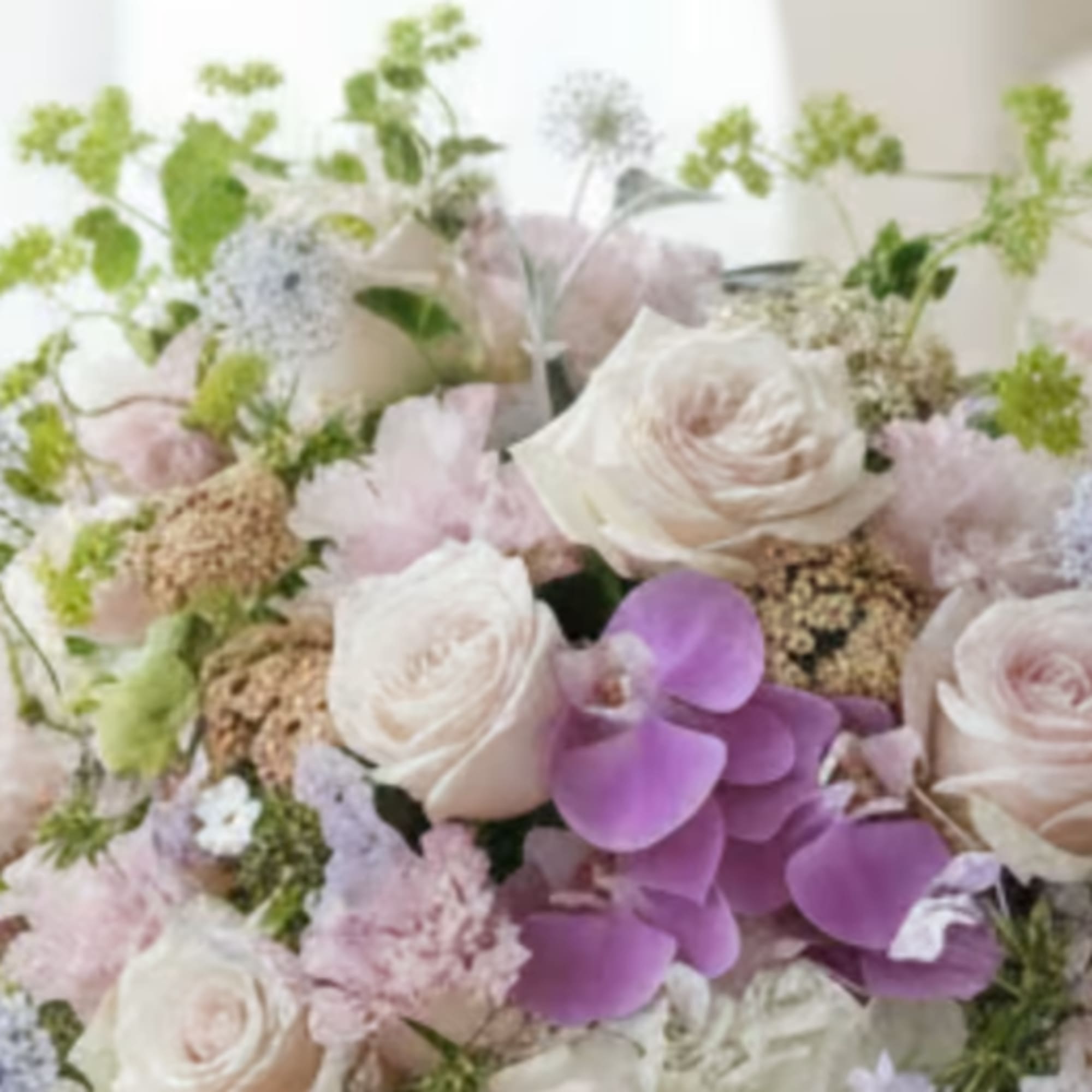 Pastel bouquet with white roses and purple orchids