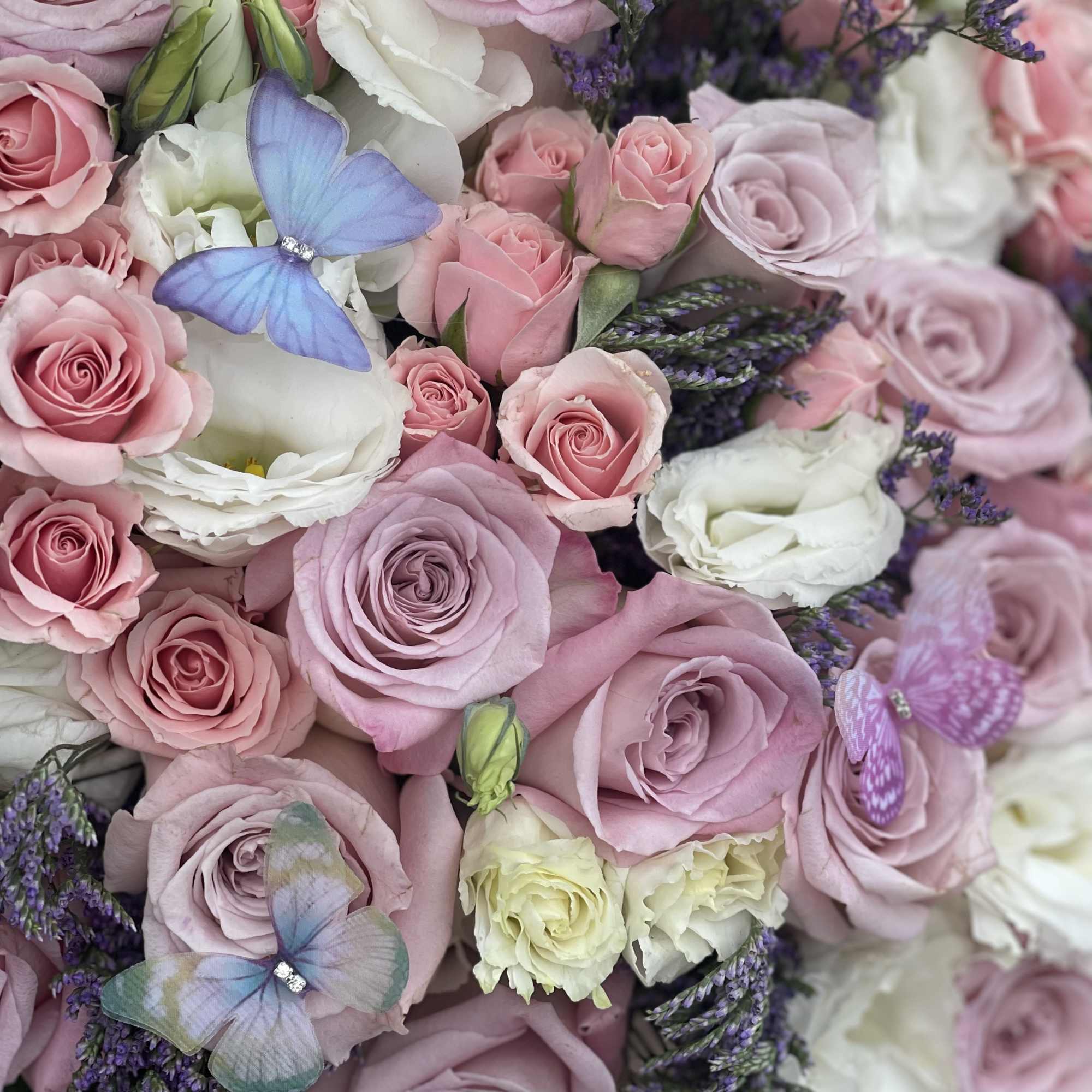 Beautiful pastel color arrangement with little butterflies in it

Standard &ndash; pictured 
Deluxe, photo 2 of 2