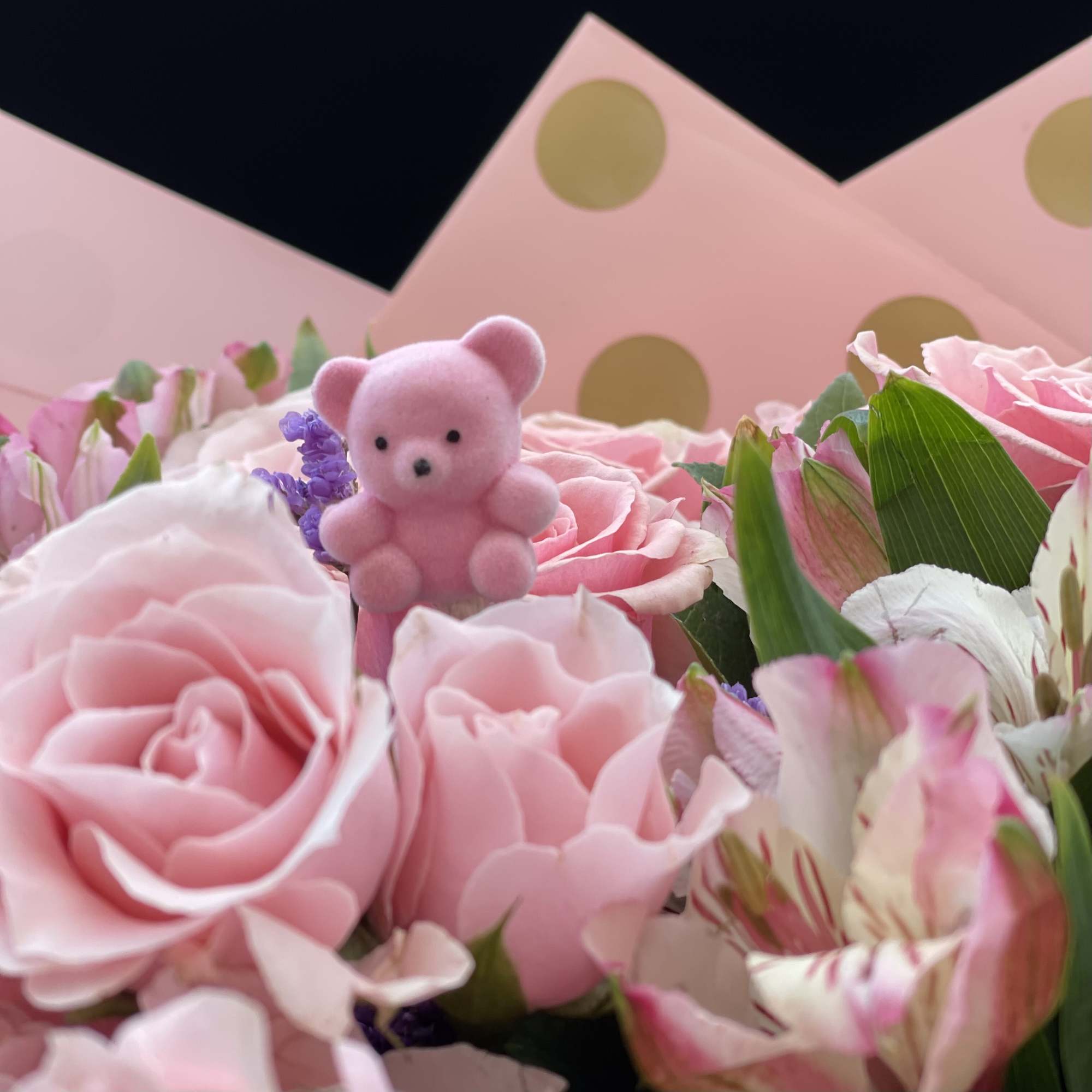 Pink rose bouquet with a small teddy bear and polka-dot wrapping