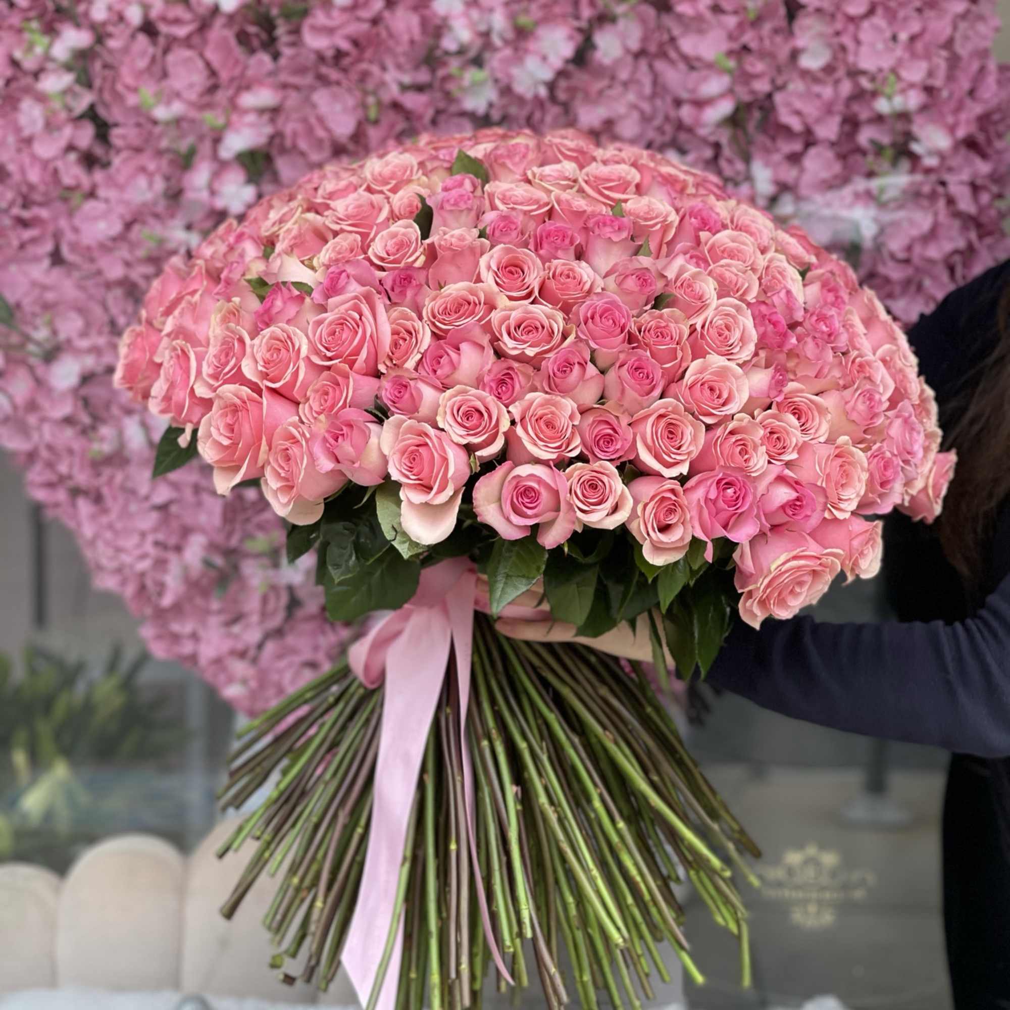 Large bouquet of pink roses tied with a pink ribbon, photo 2 of 2