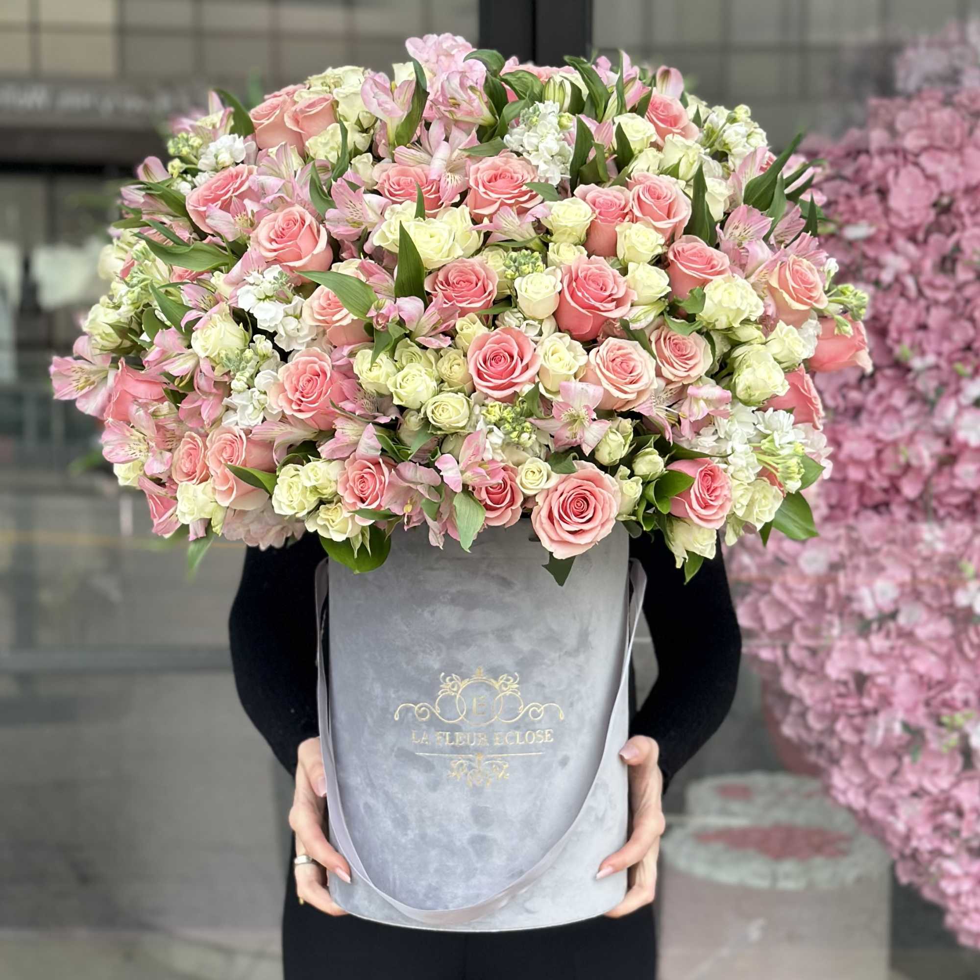 Fresh roses in a mix with garden roses and greens in a