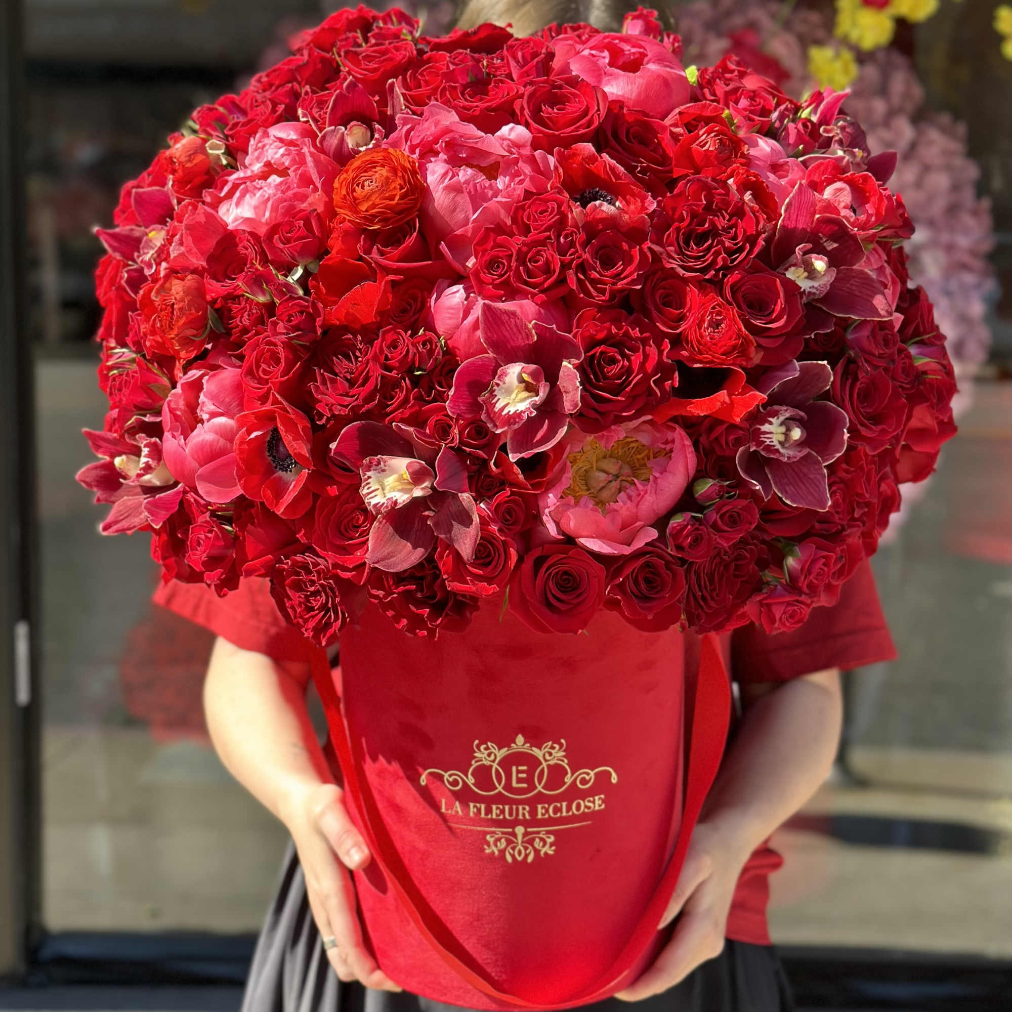 The flower arrangement features an elegant display of premium red flowers beautifully, photo 2 of 2