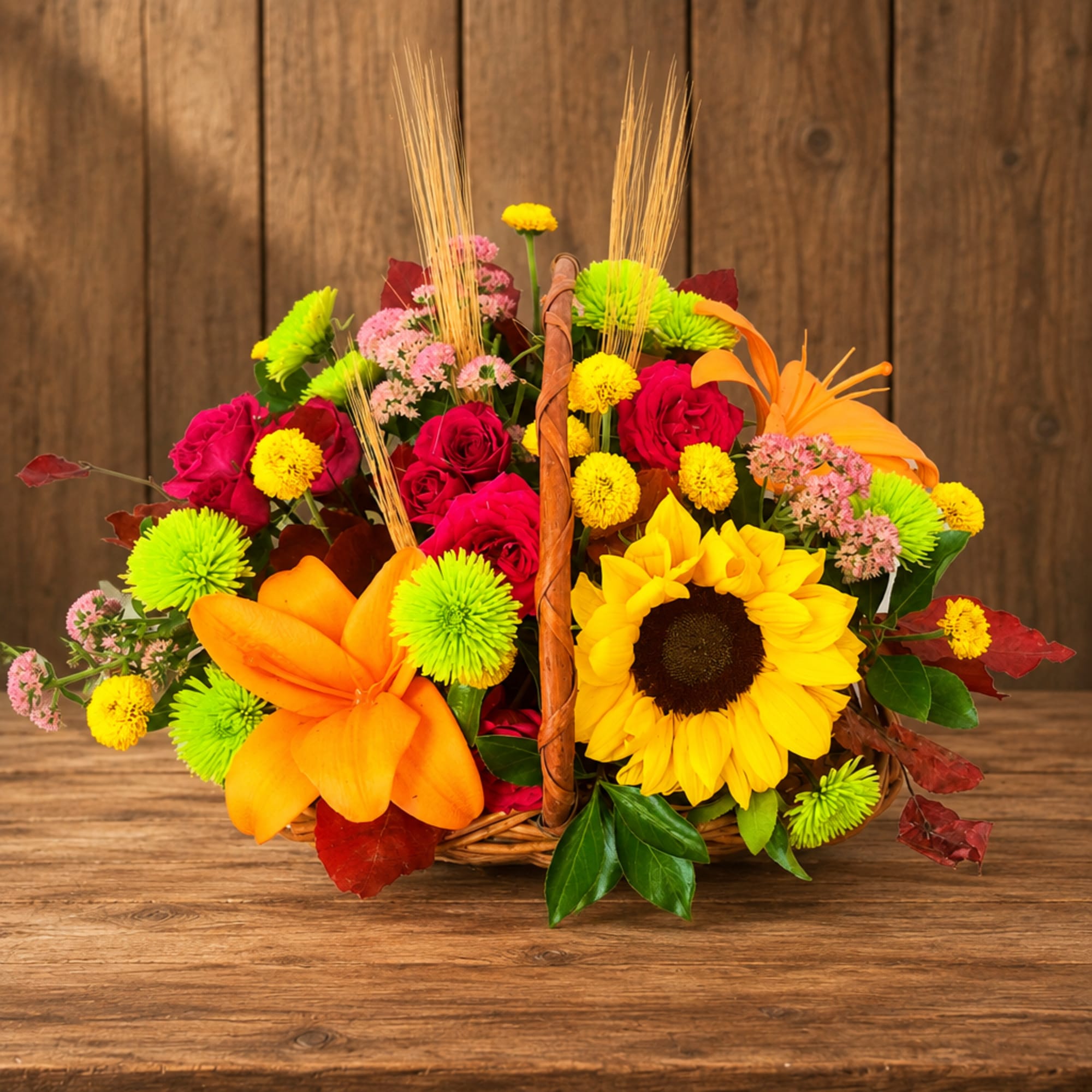 Basket arrangement with sunflowers, roses, and orange lilies