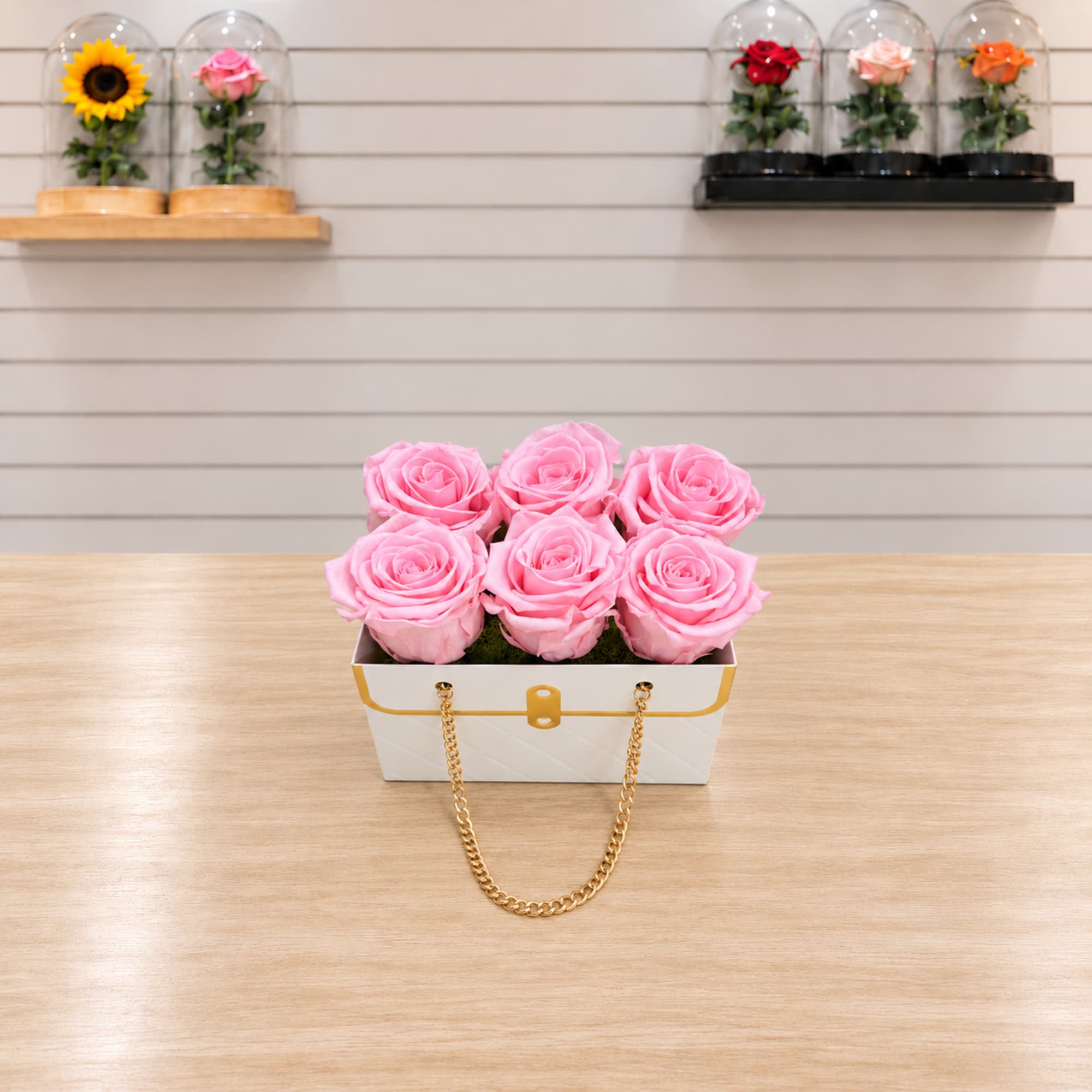 Pink roses in a white handbag-style box with a gold chain handle, photo 2 of 2
