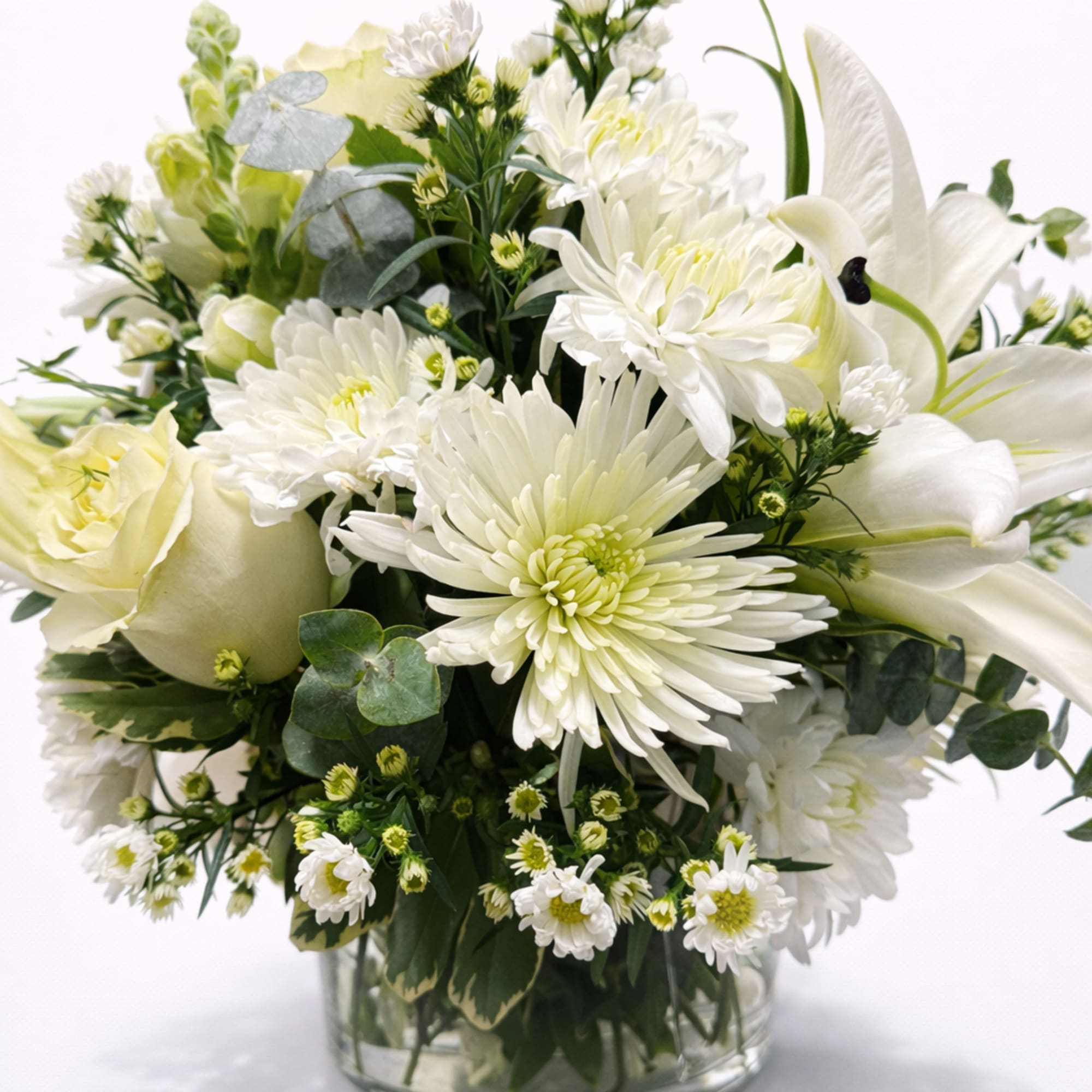 White lilies rise above a rounded cluster of white chrysanthemums and small, photo 2 of 2