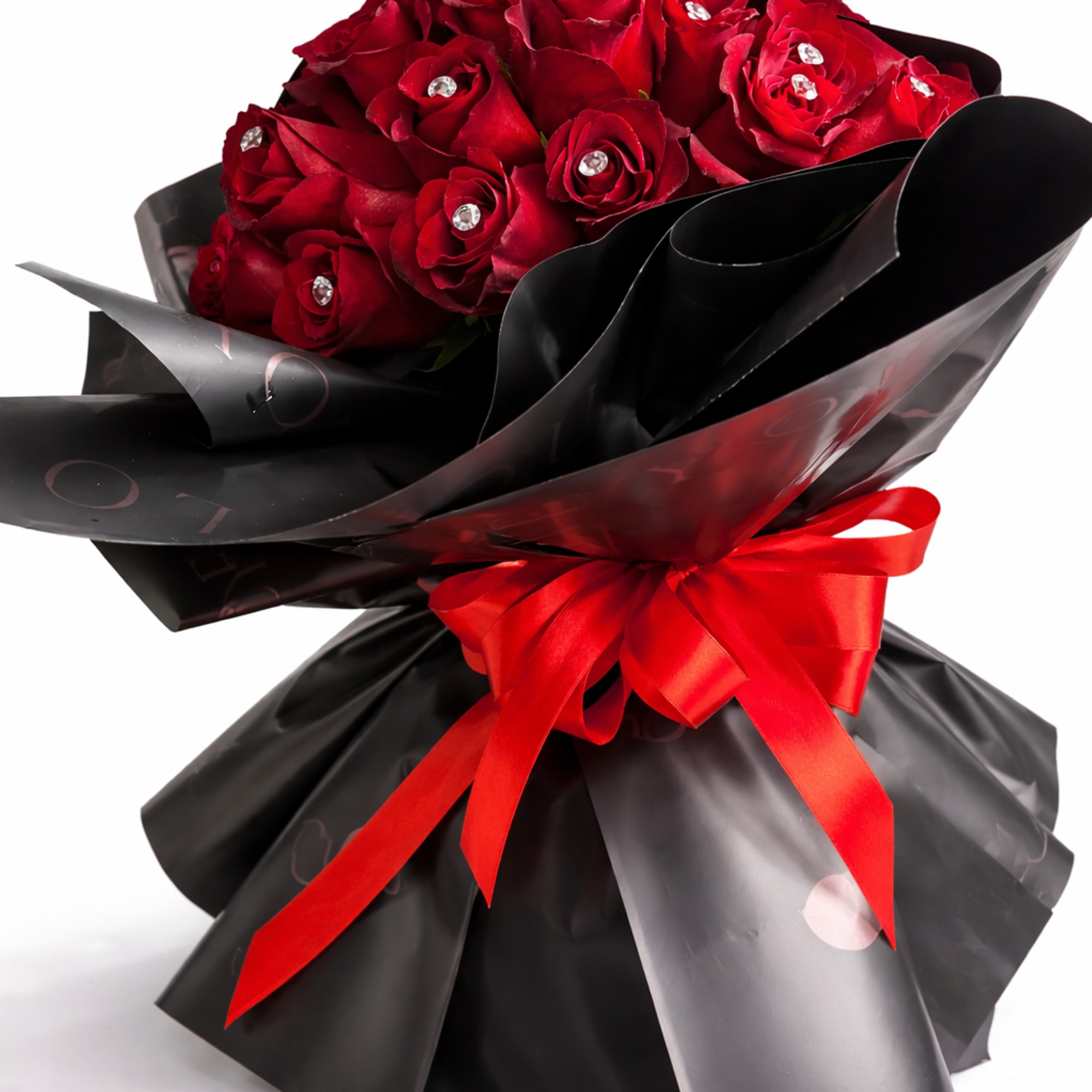 Bouquet of red roses wrapped in black paper with a red ribbon
