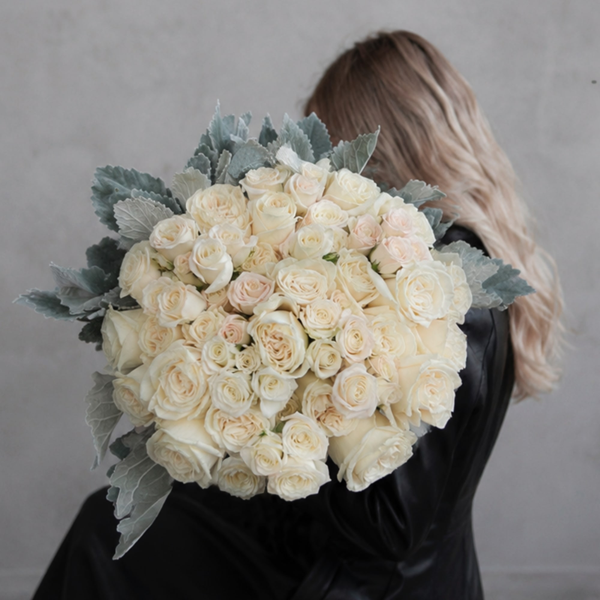 Large bouquet of cream roses with silvery foliage