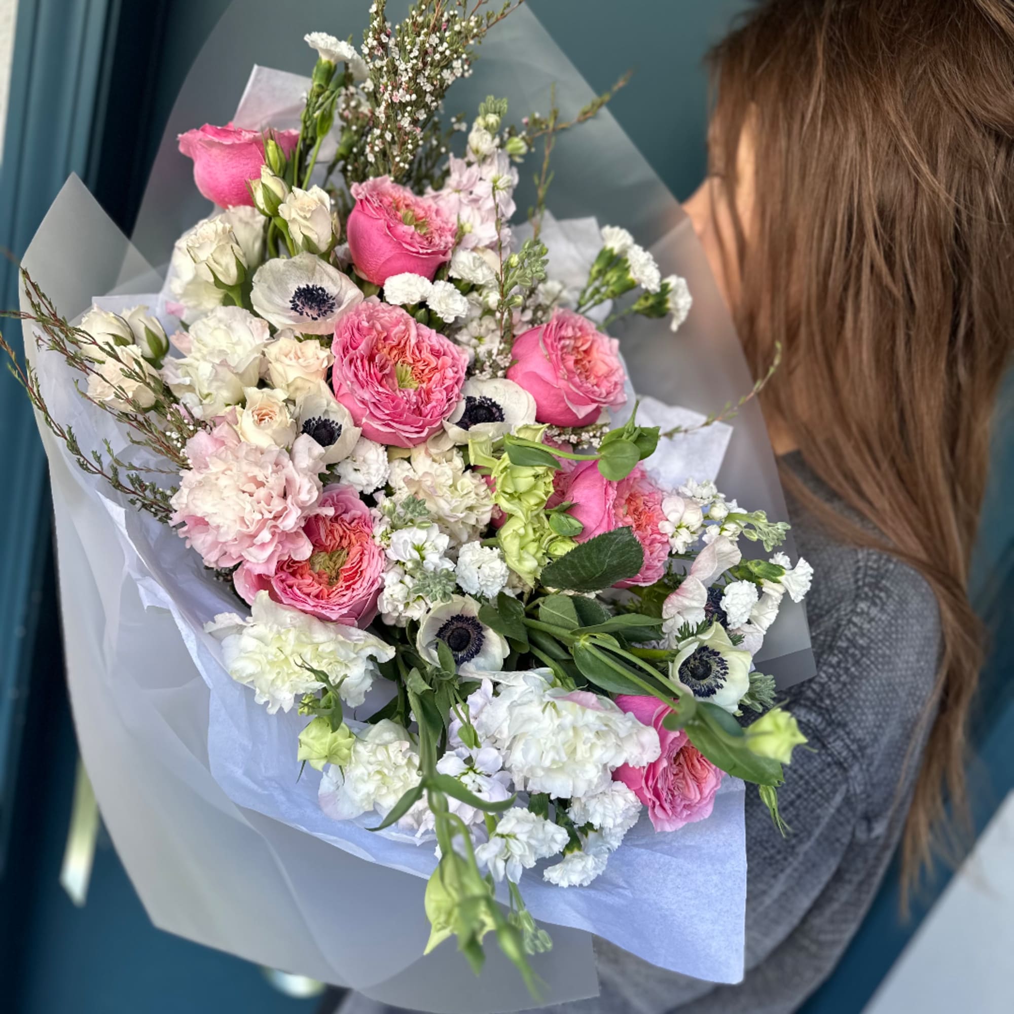 Pink and white mixed bouquet wrapped in translucent paper