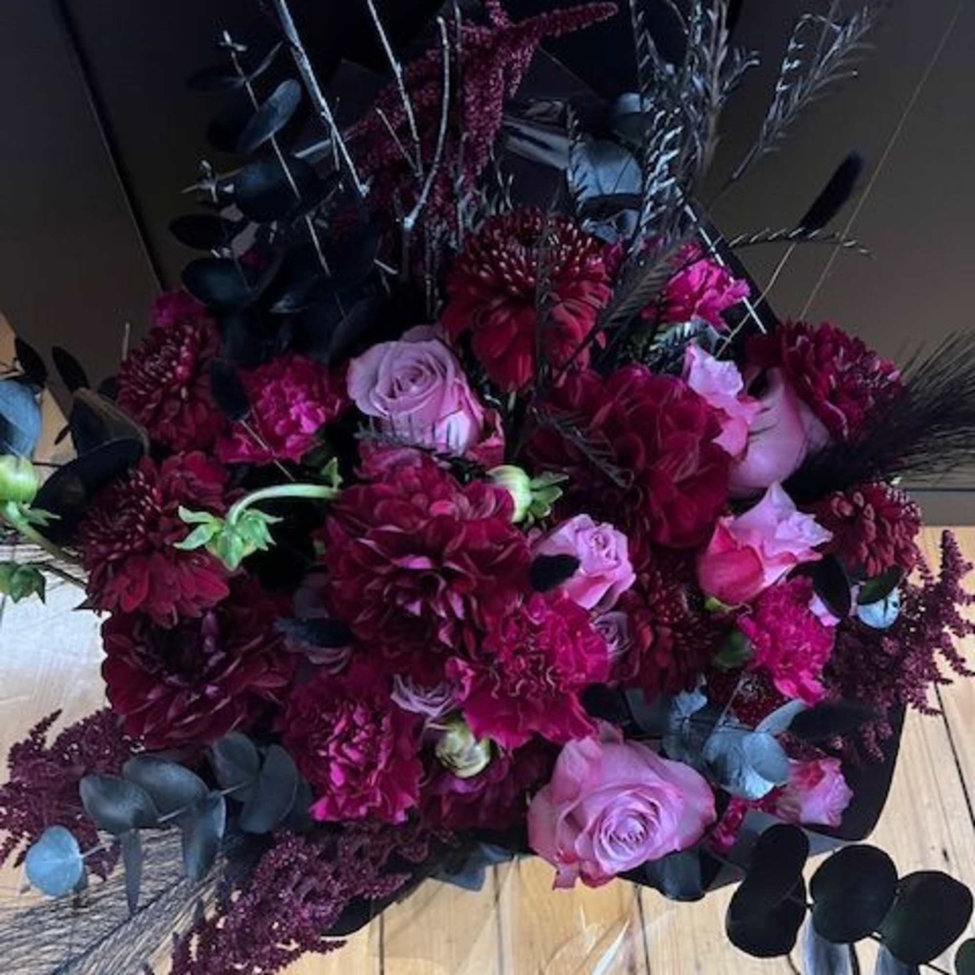 Bouquet of burgundy and pink flowers with dark foliage