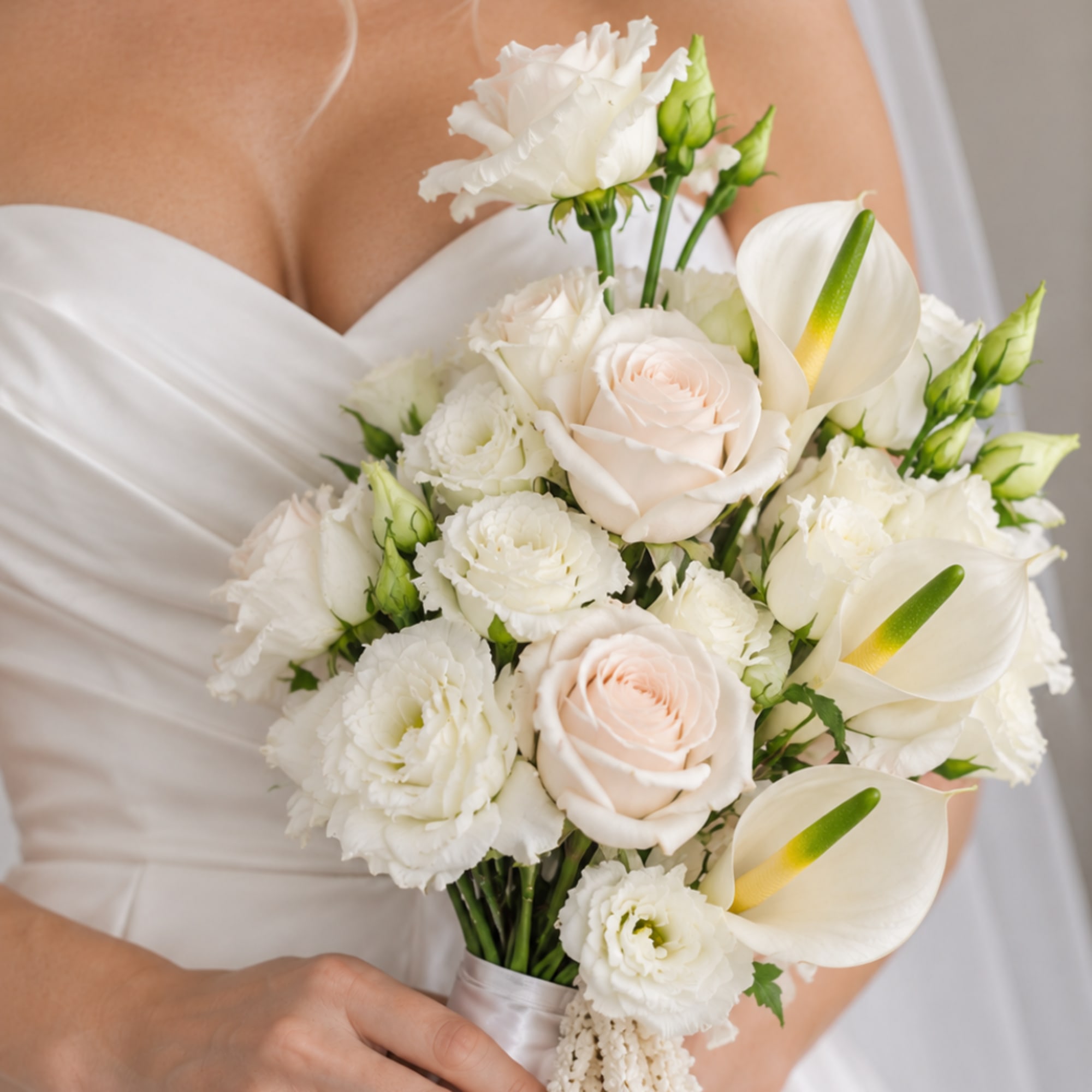 Bride holding a white bouquet with roses, calla lilies, and carnations