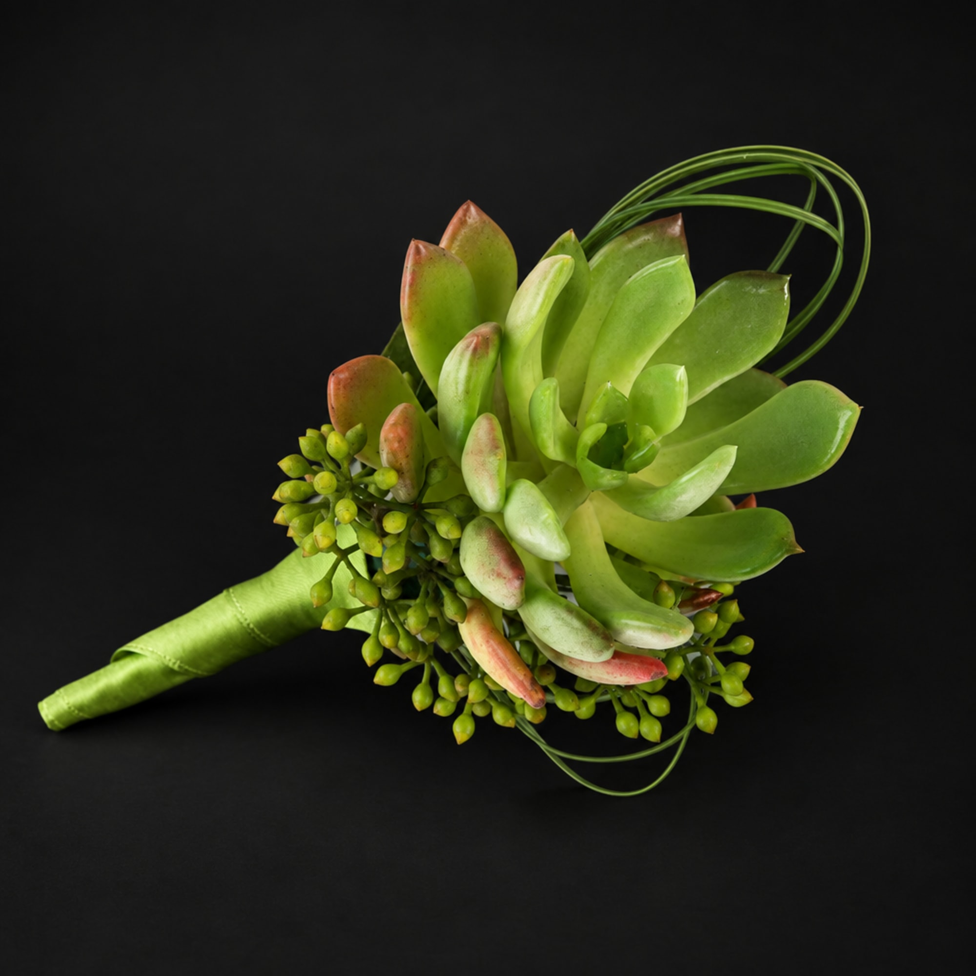 Succulent bouquet with green rosette leaves and berry accents