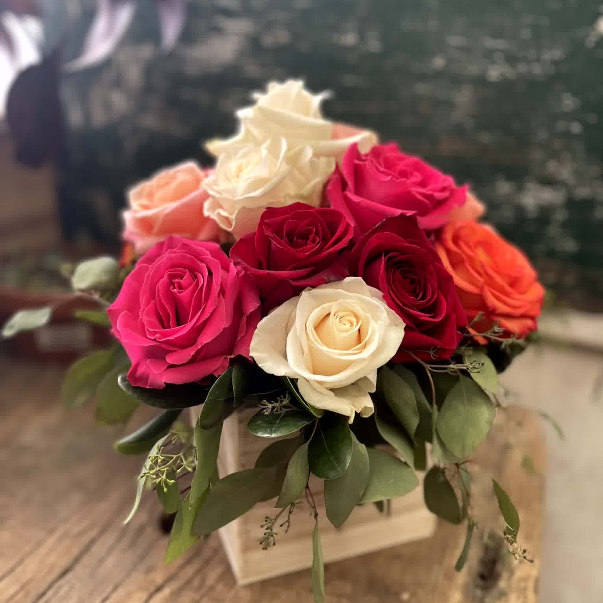 Bouquet of pink, red, and white roses in a square box