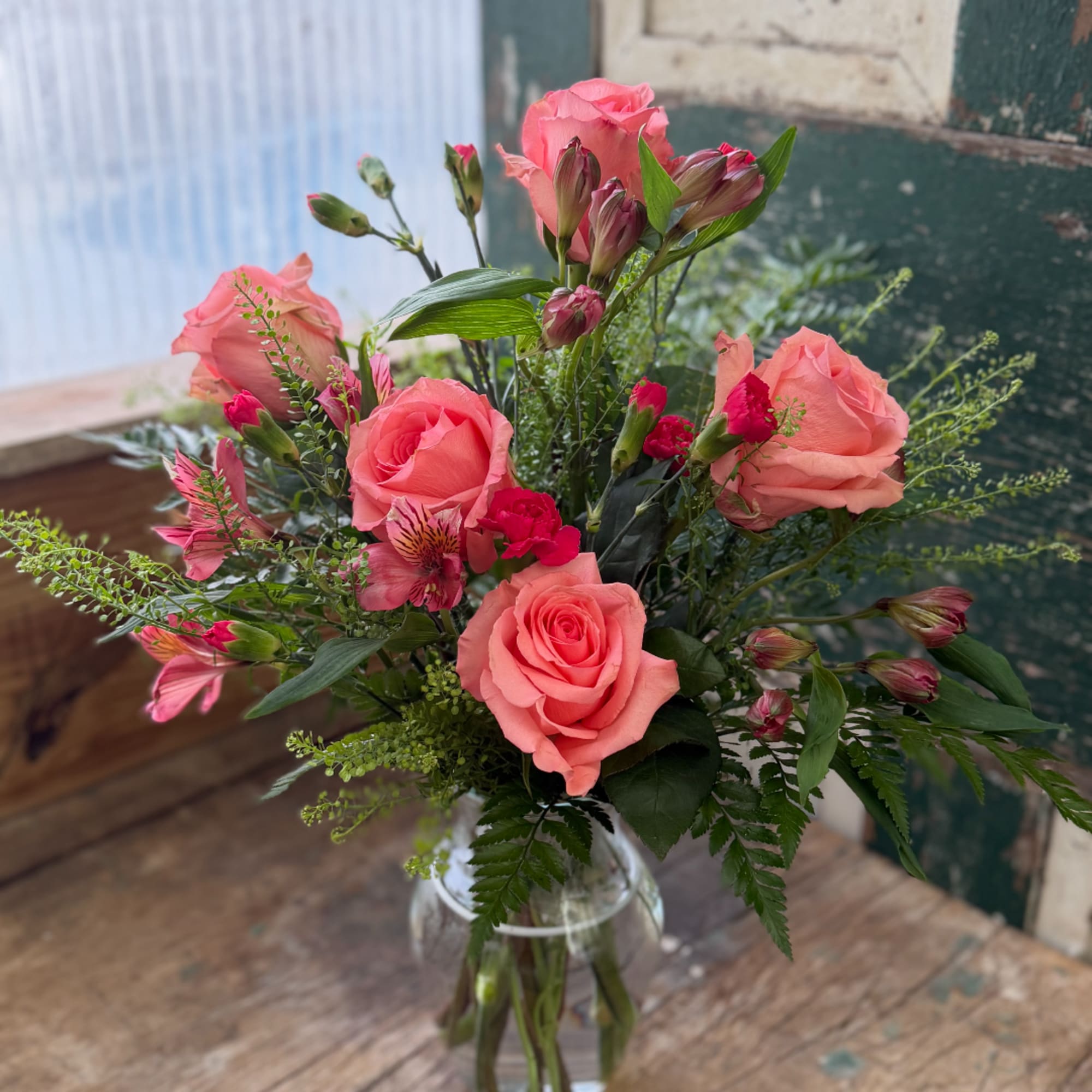 Pink roses and alstroemeria in a clear glass vase, photo 2 of 2