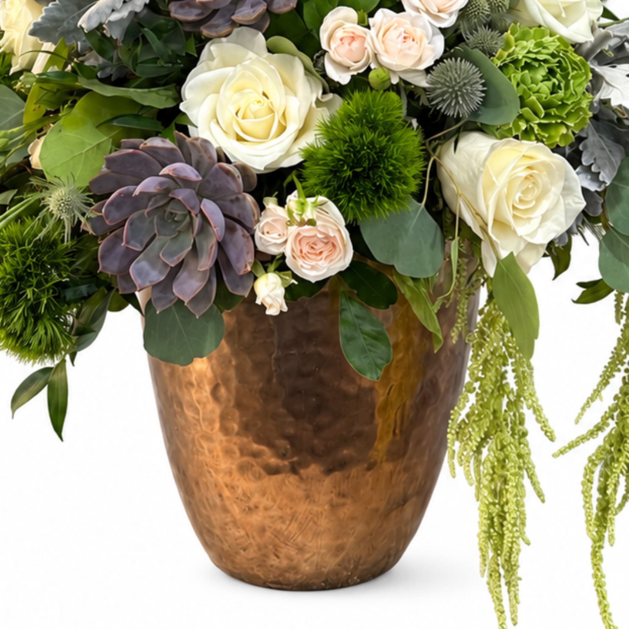 Mixed floral arrangement with white roses and succulents in a copper vase