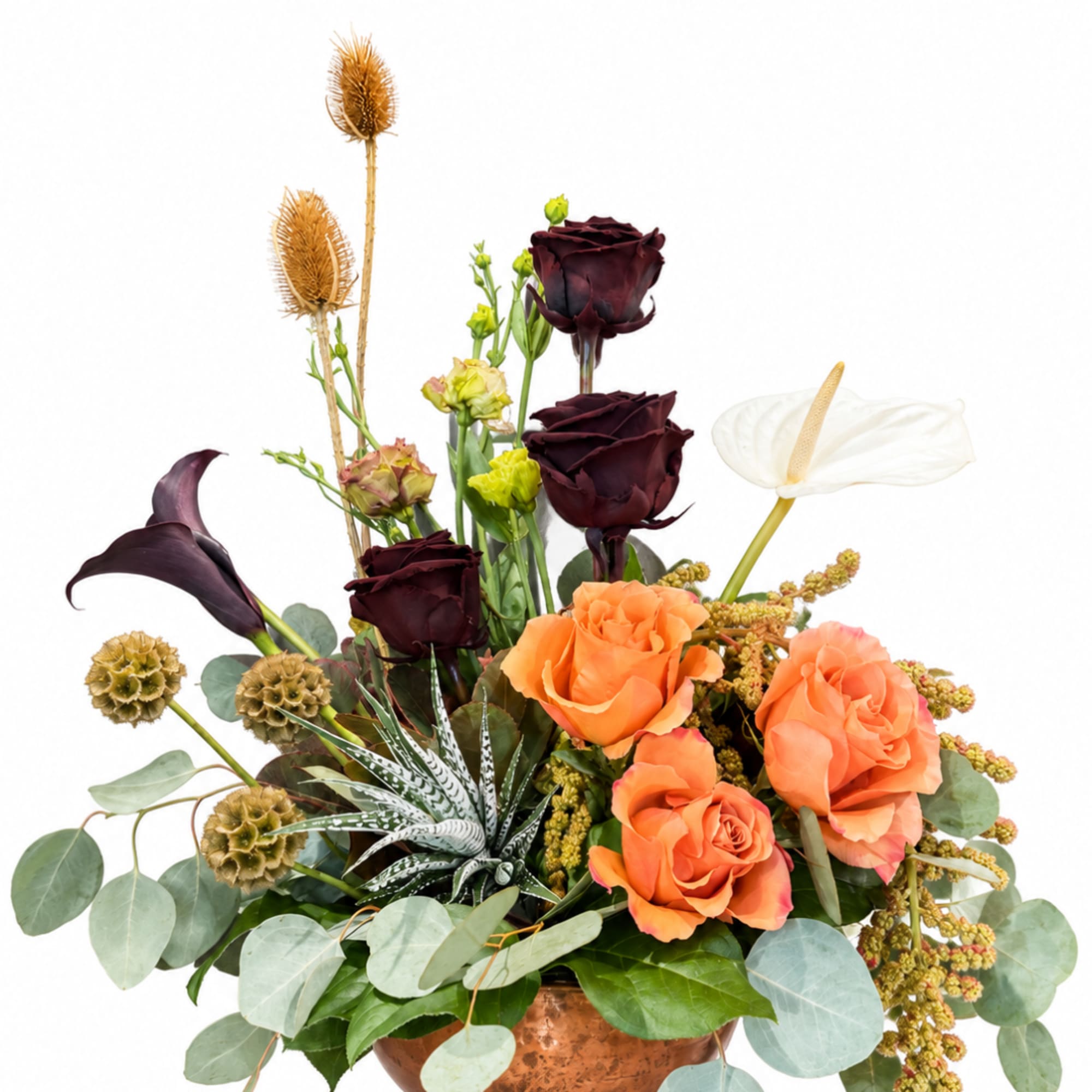 Arrangement of orange and dark burgundy roses with white anthurium in a copper vase