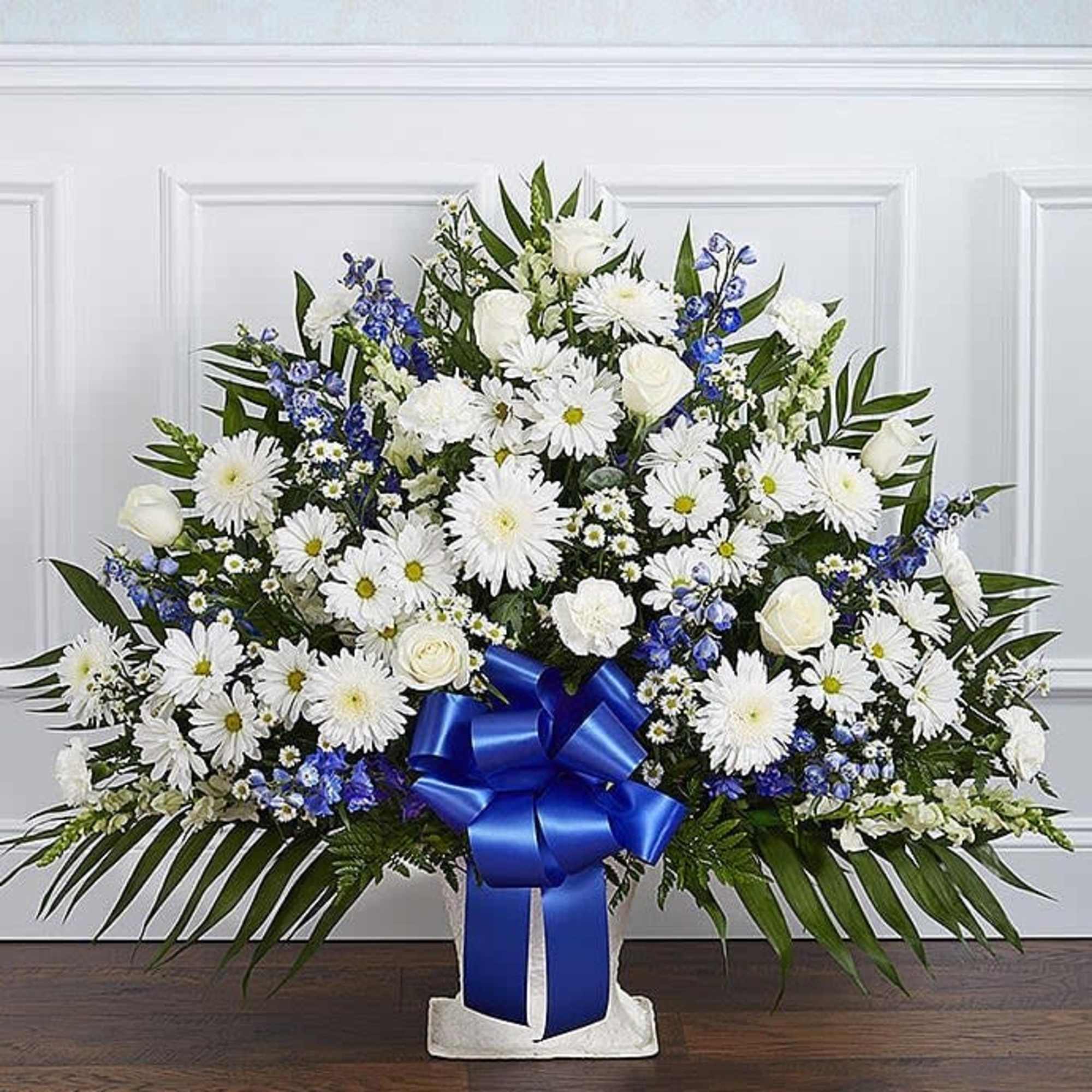 White daisy and rose arrangement with blue ribbon in a vase