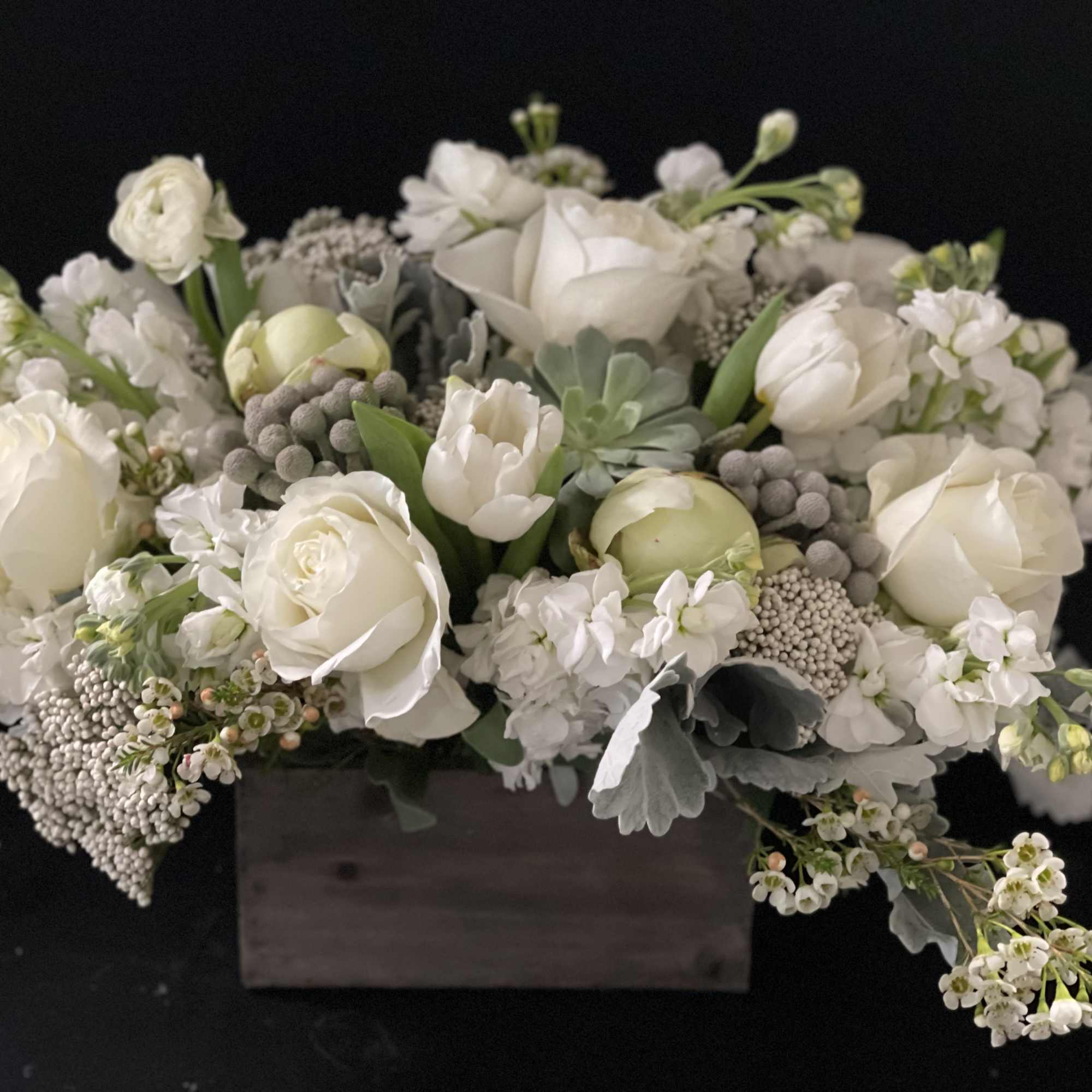 White floral arrangement in a rectangular wooden box