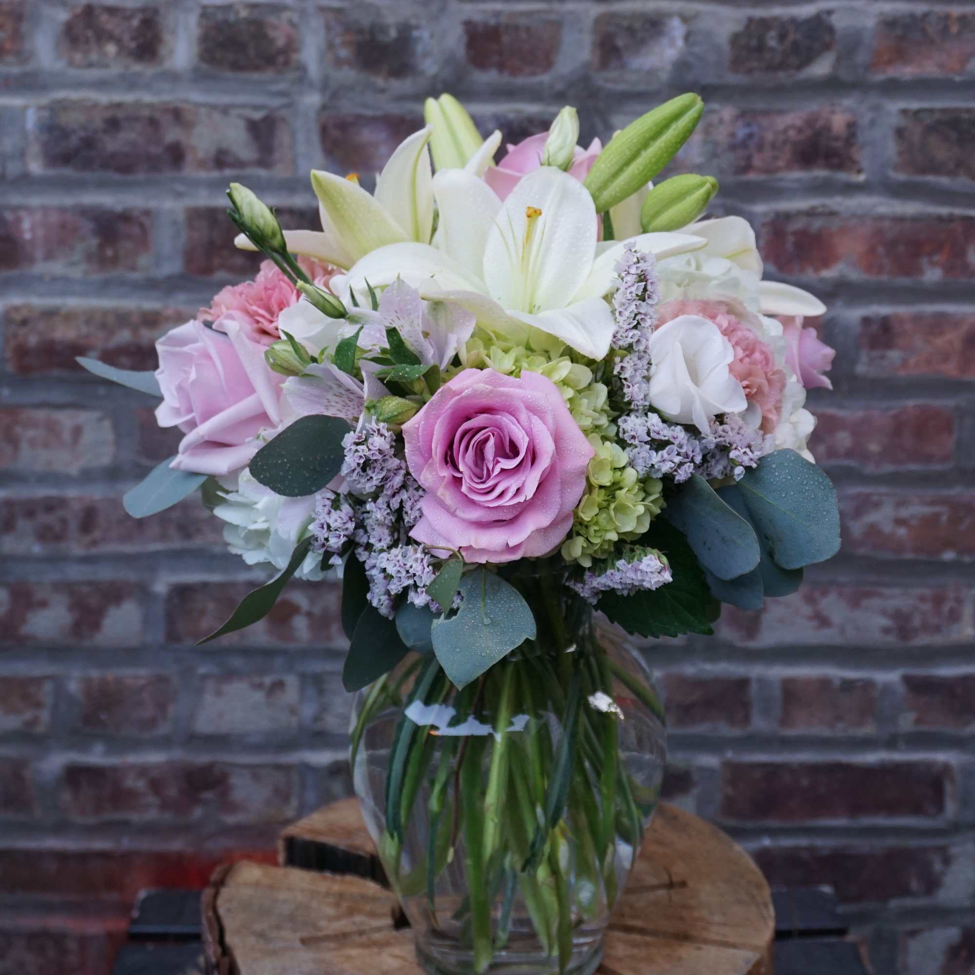 Pink and white bouquet in a clear glass vase