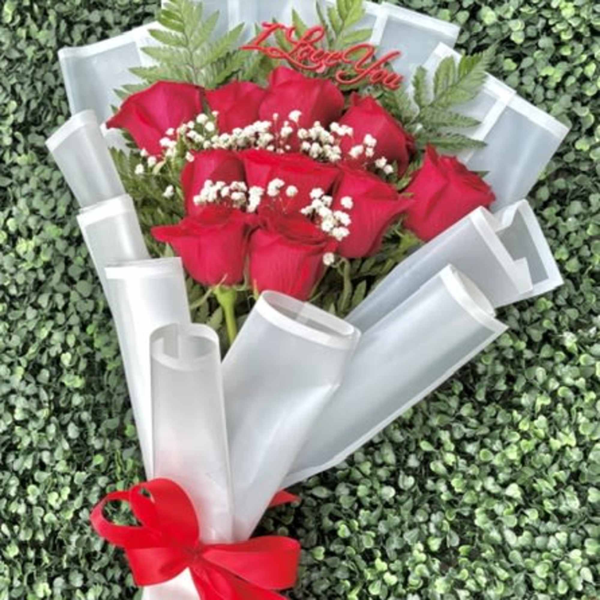 Vivid red roses take center stage in this Congrats Grad bouquet, making