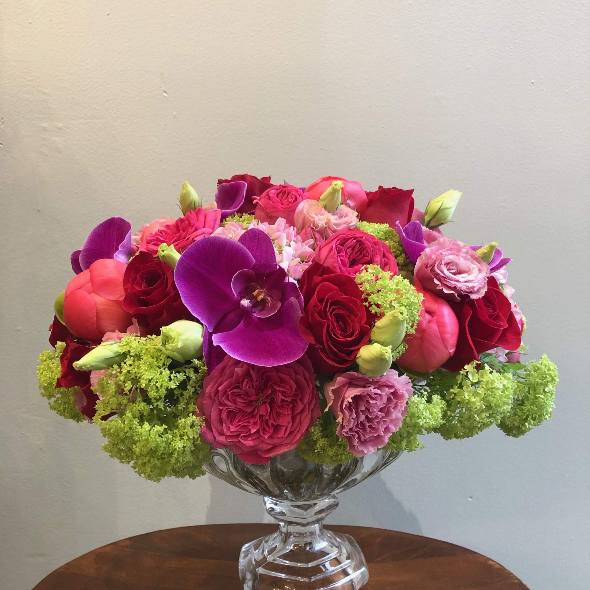 Pink and red floral arrangement in a clear glass vase