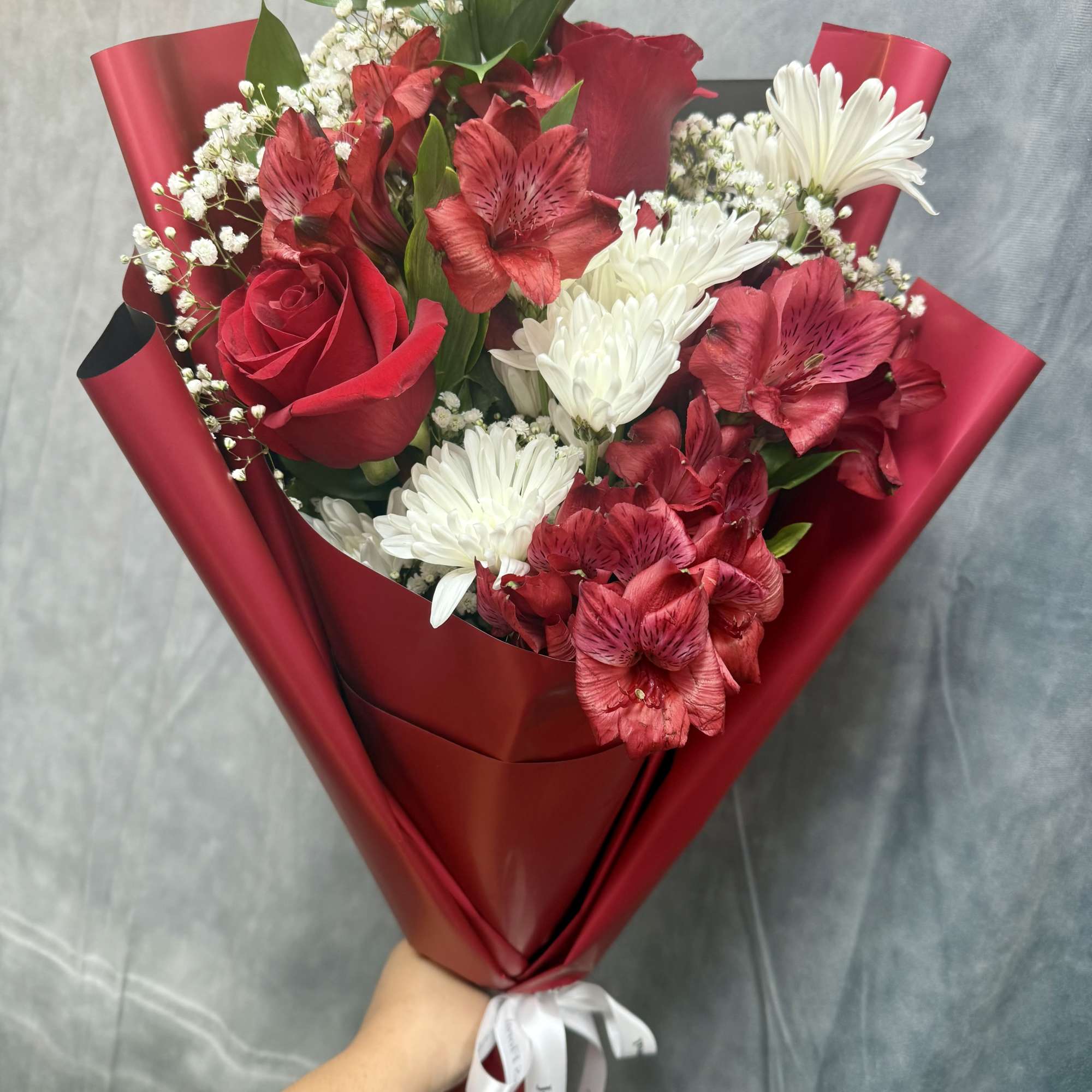 Red and white mixed bouquet with roses, daisies, and alstroemeria