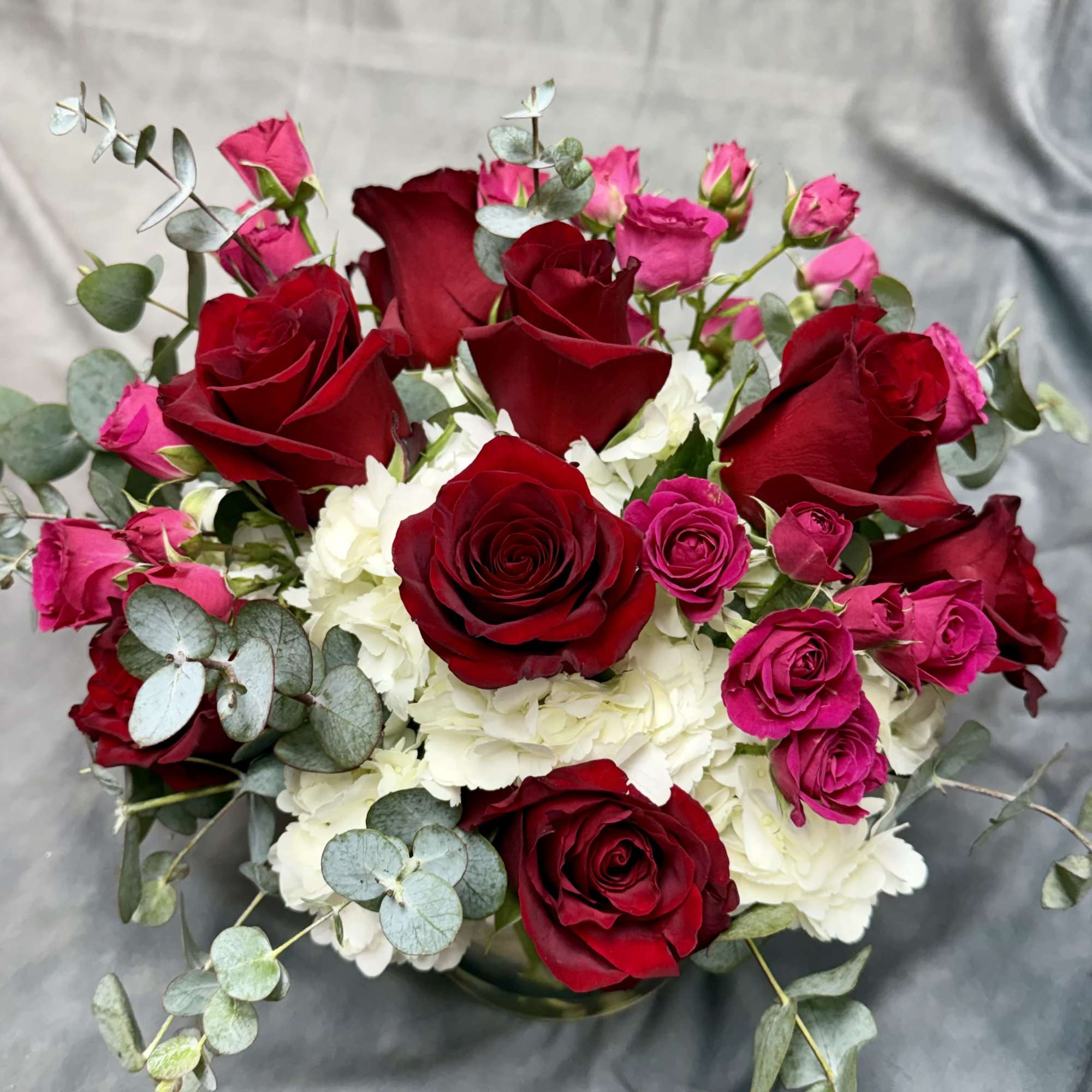 Bouquet of red and pink roses with white hydrangeas
