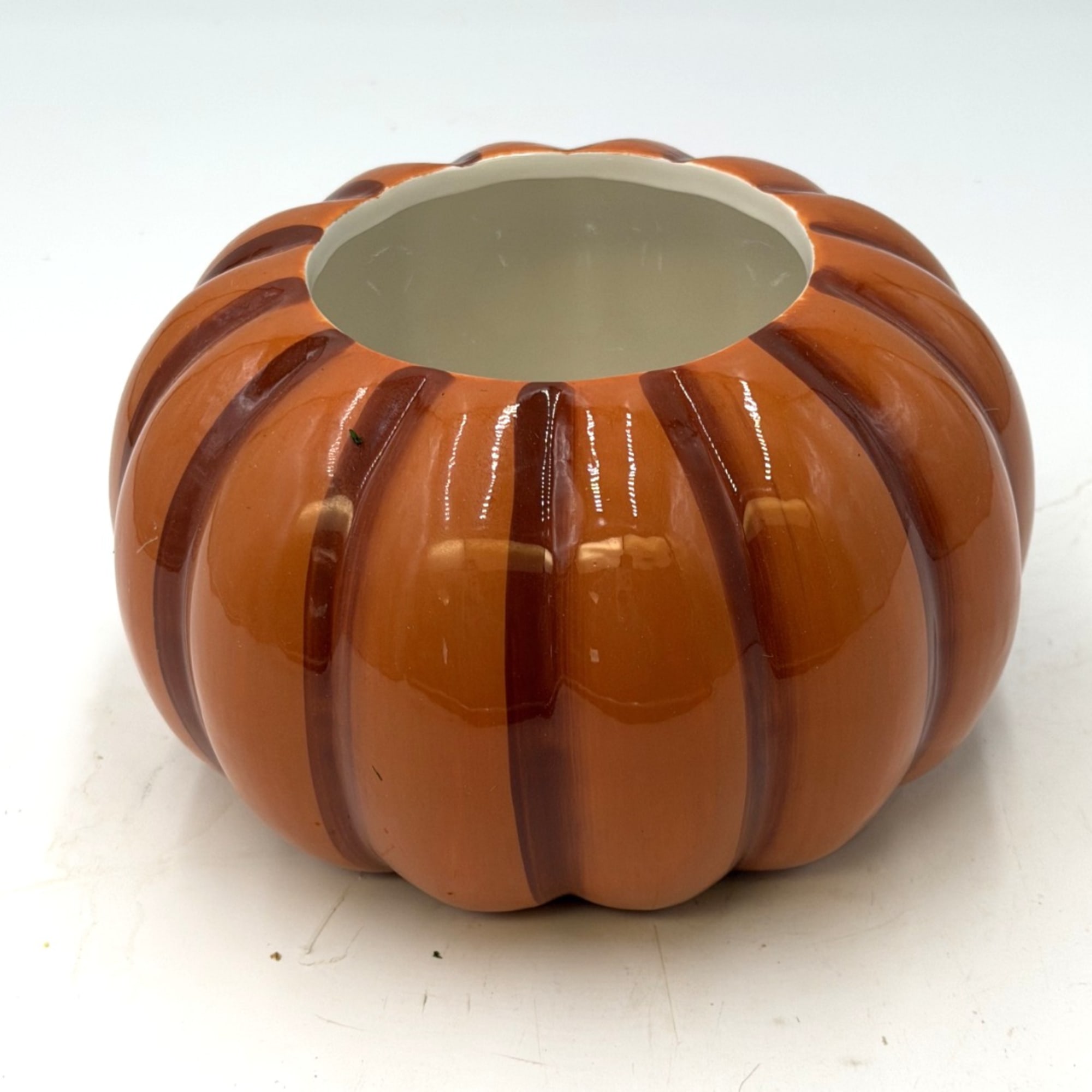 Orange pumpkin-shaped ceramic vase with a wide opening