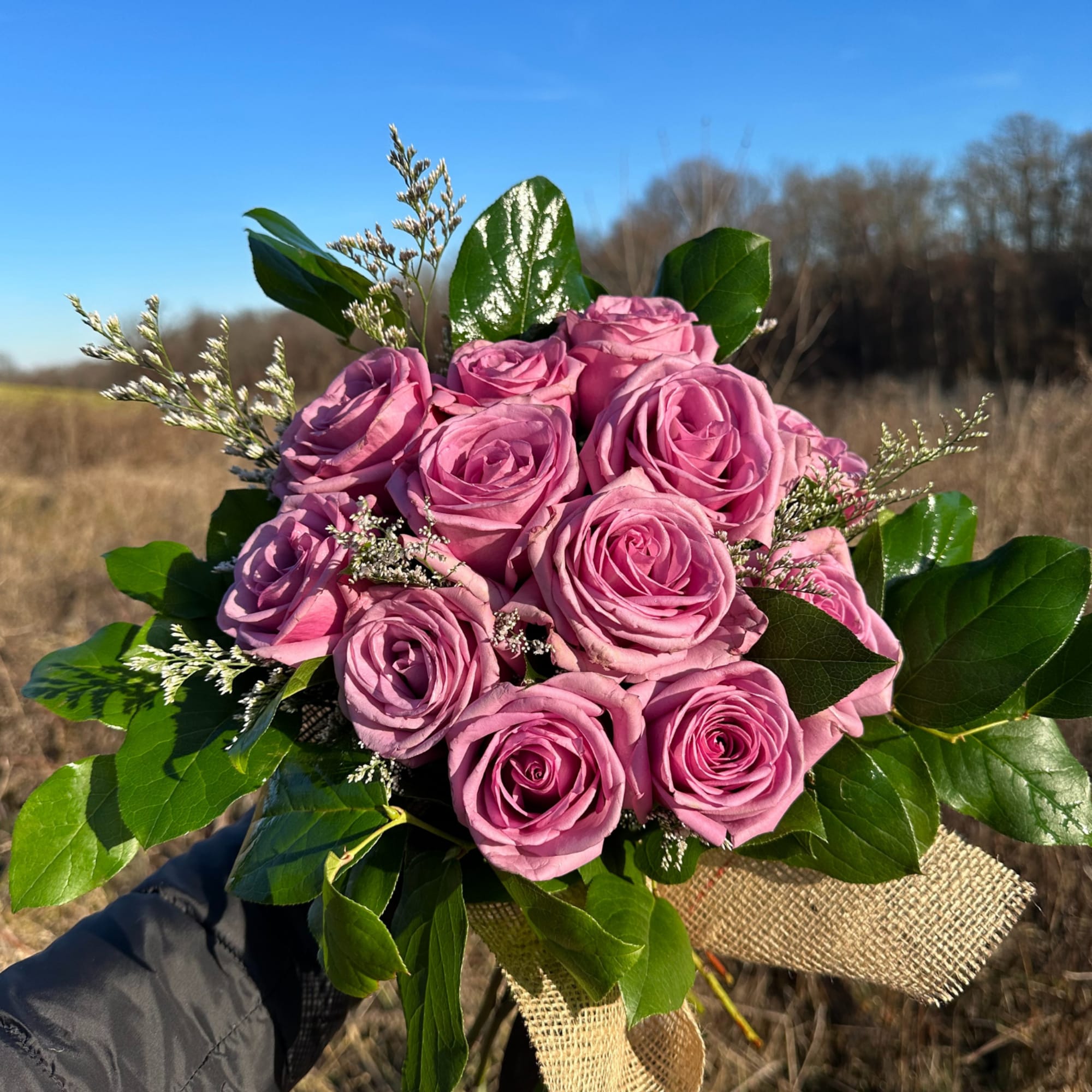 A lush cluster of two dozen hand-tied roses makes an unforgettable romantic