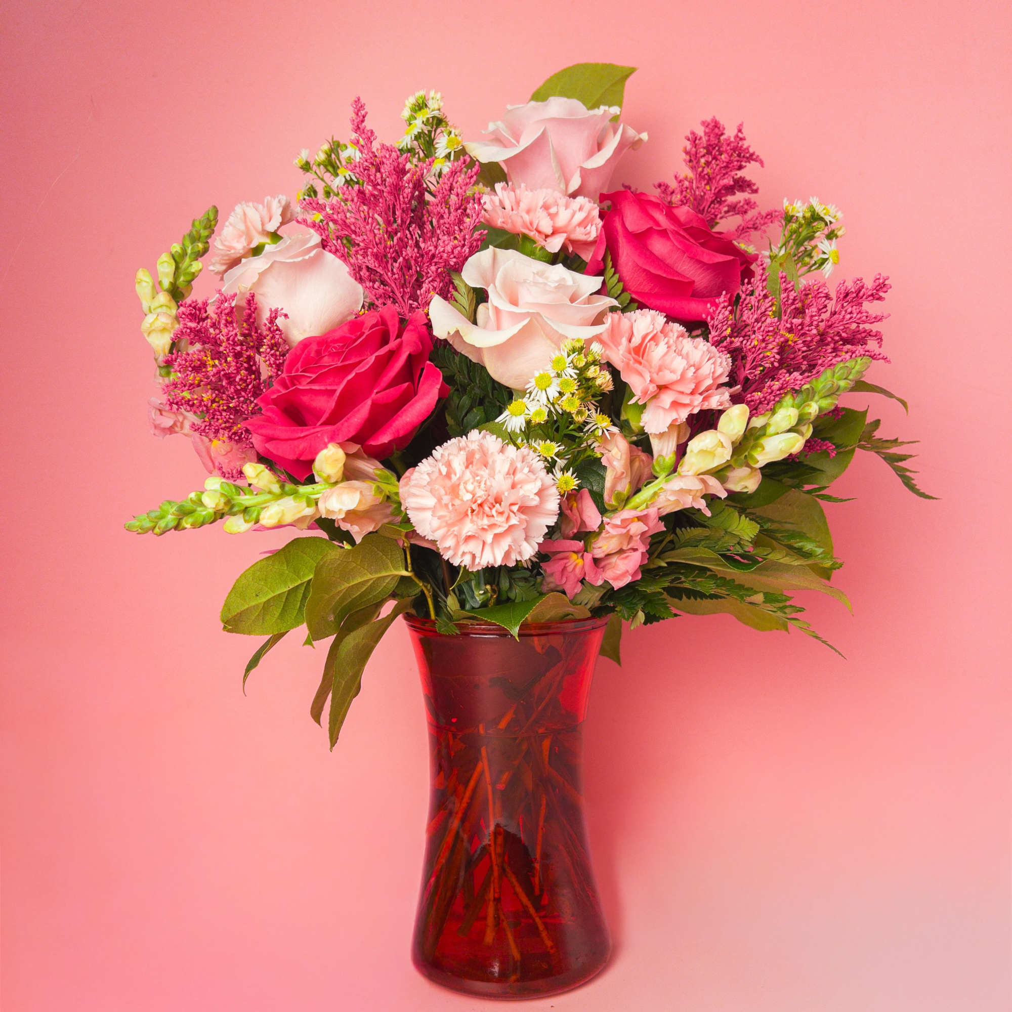 A cheerful contrast of hot pink and pastel blooms, flawlessly styled in