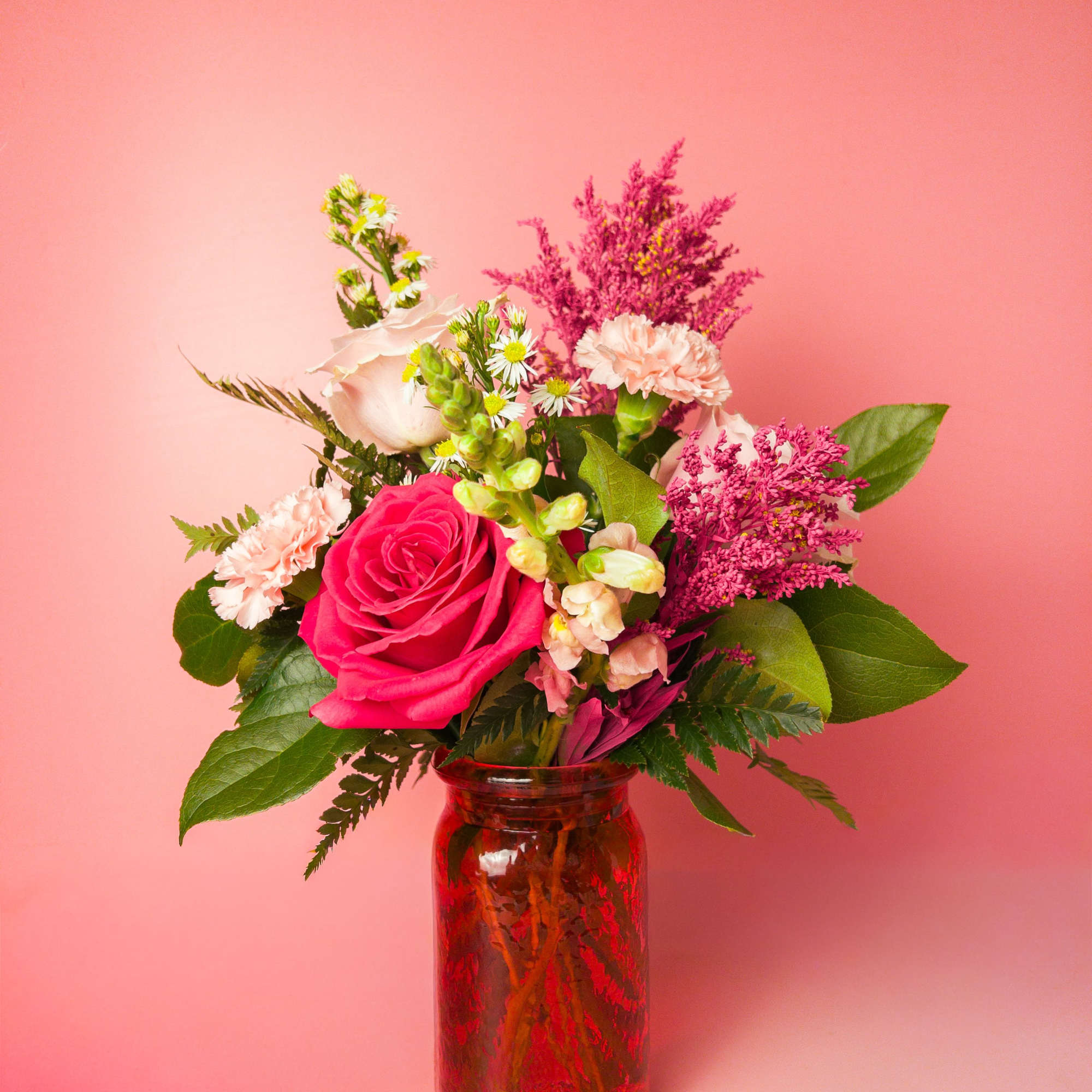 A cheerful contrast of hot pink and pastel blooms, flawlessly styled in