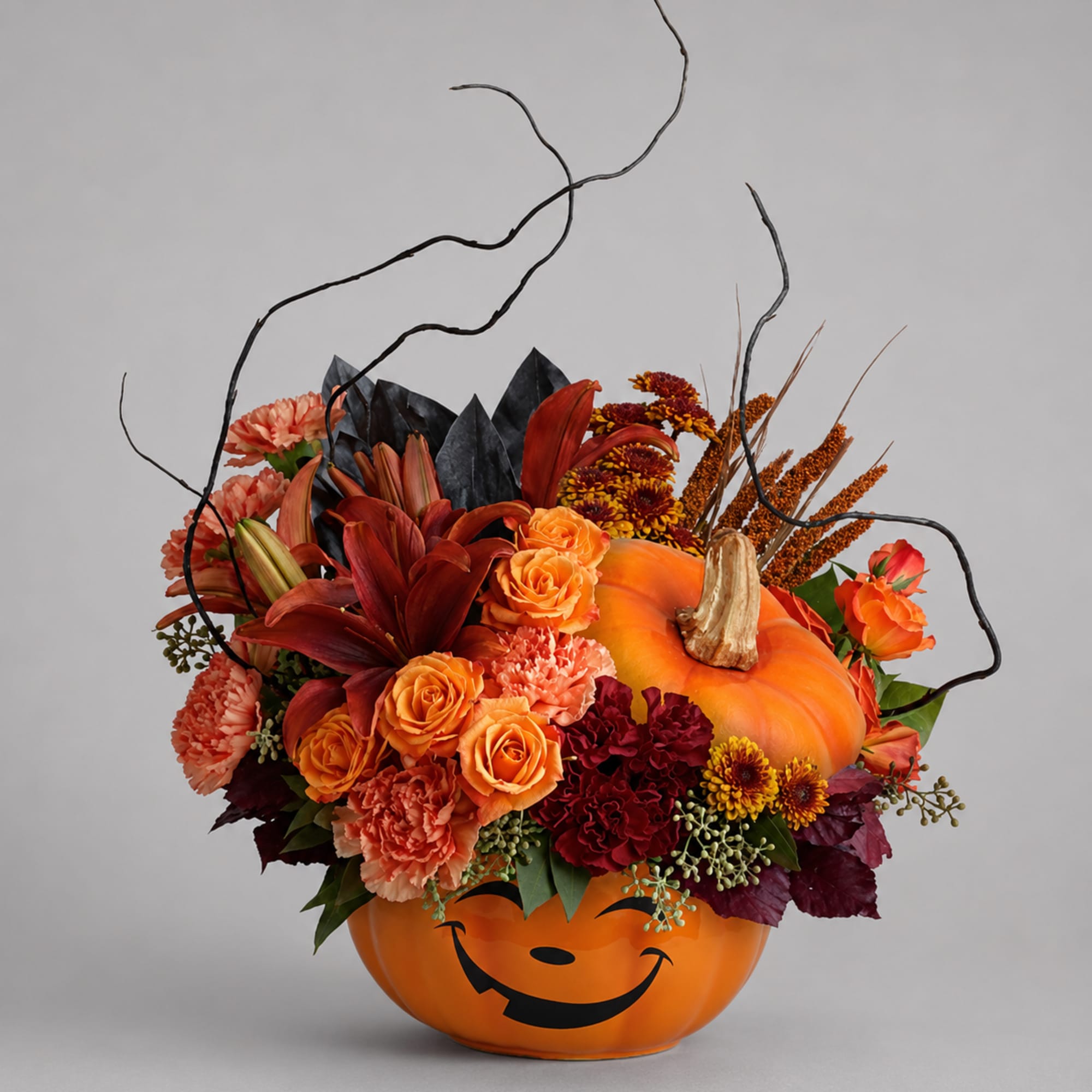 Halloween pumpkin container filled with orange and red flowers