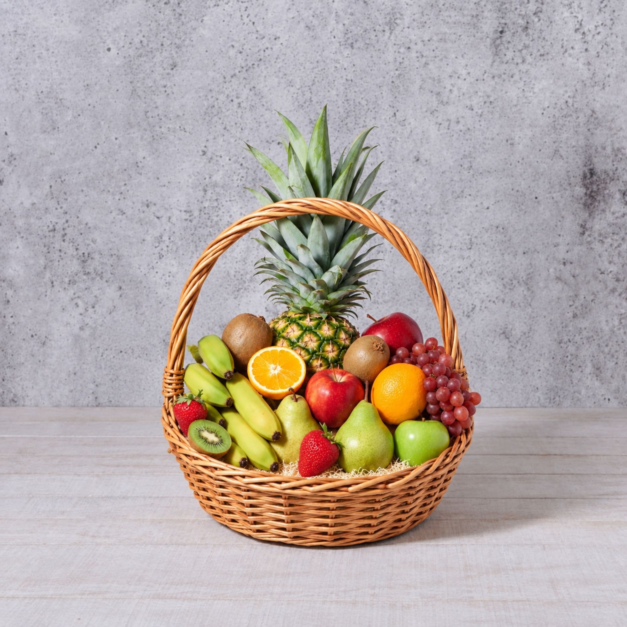 Fruit basket with pineapple, bananas, apples, pears, grapes, kiwi, oranges, and strawberries