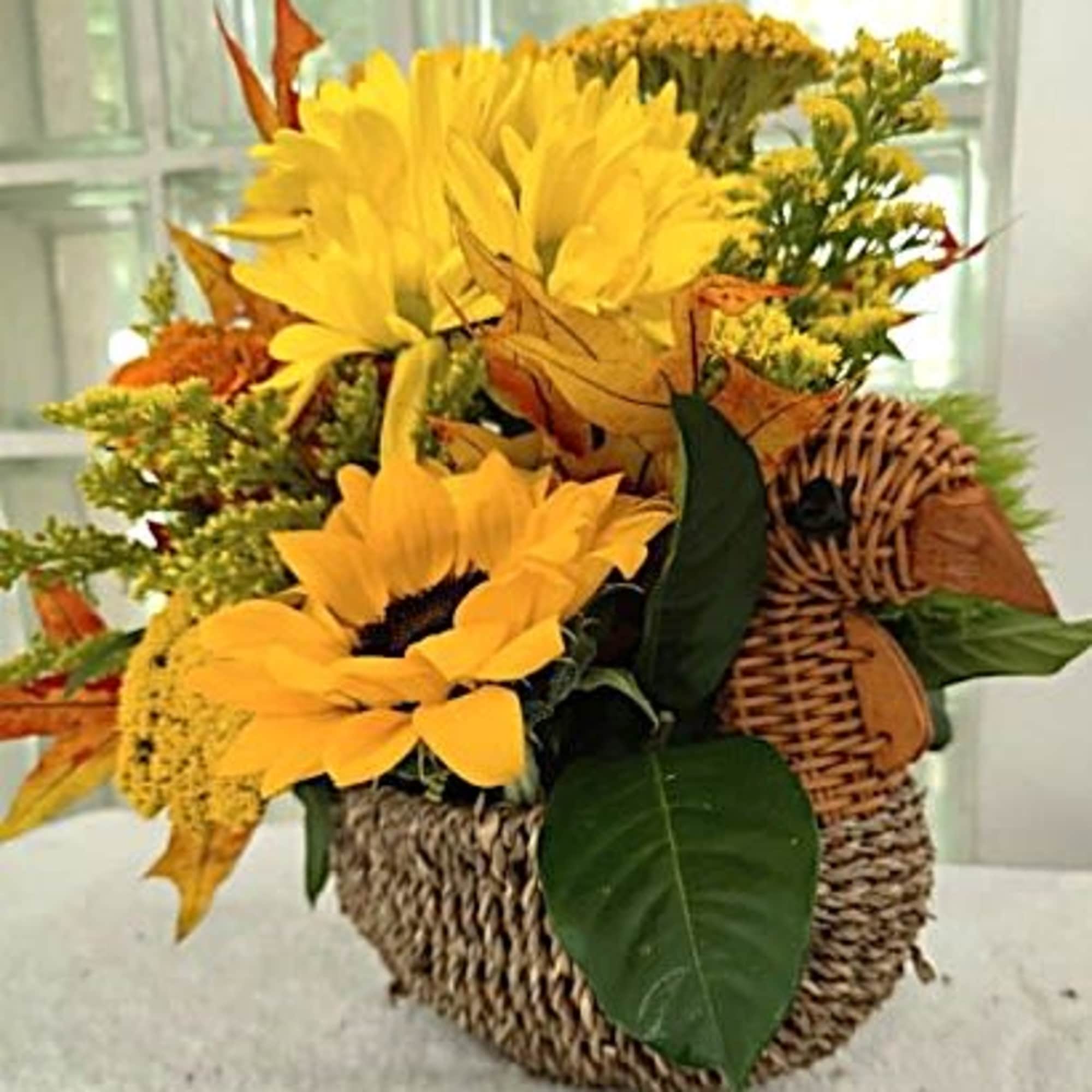 This cute little woven rattan turkey contains a beautiful, fall colored centerpiece