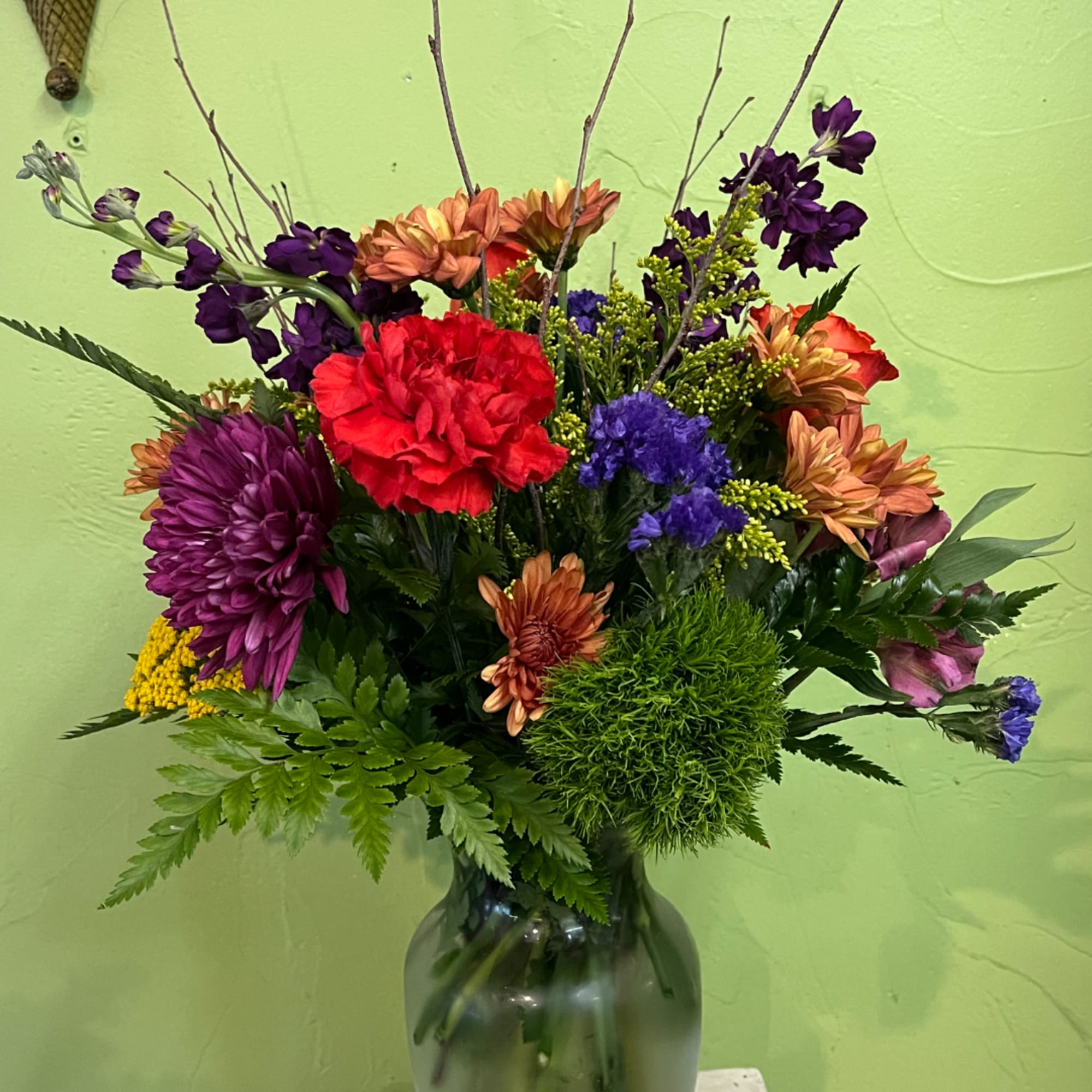 Colorful mixed flower arrangement in a glass vase