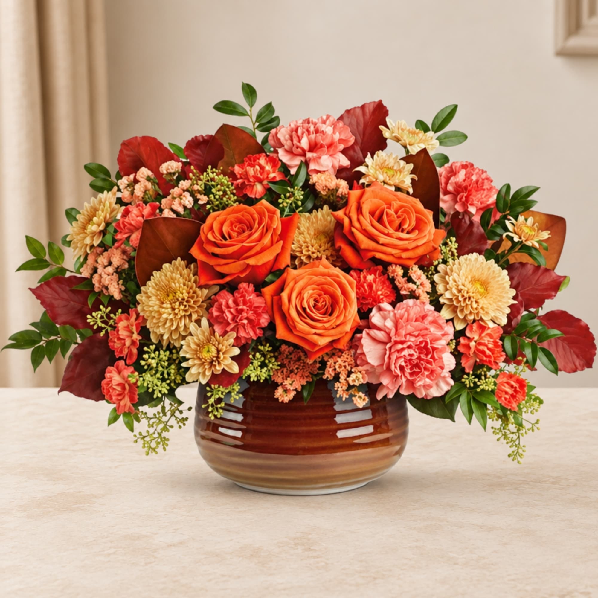 Orange roses and pink carnations in a brown ceramic vase