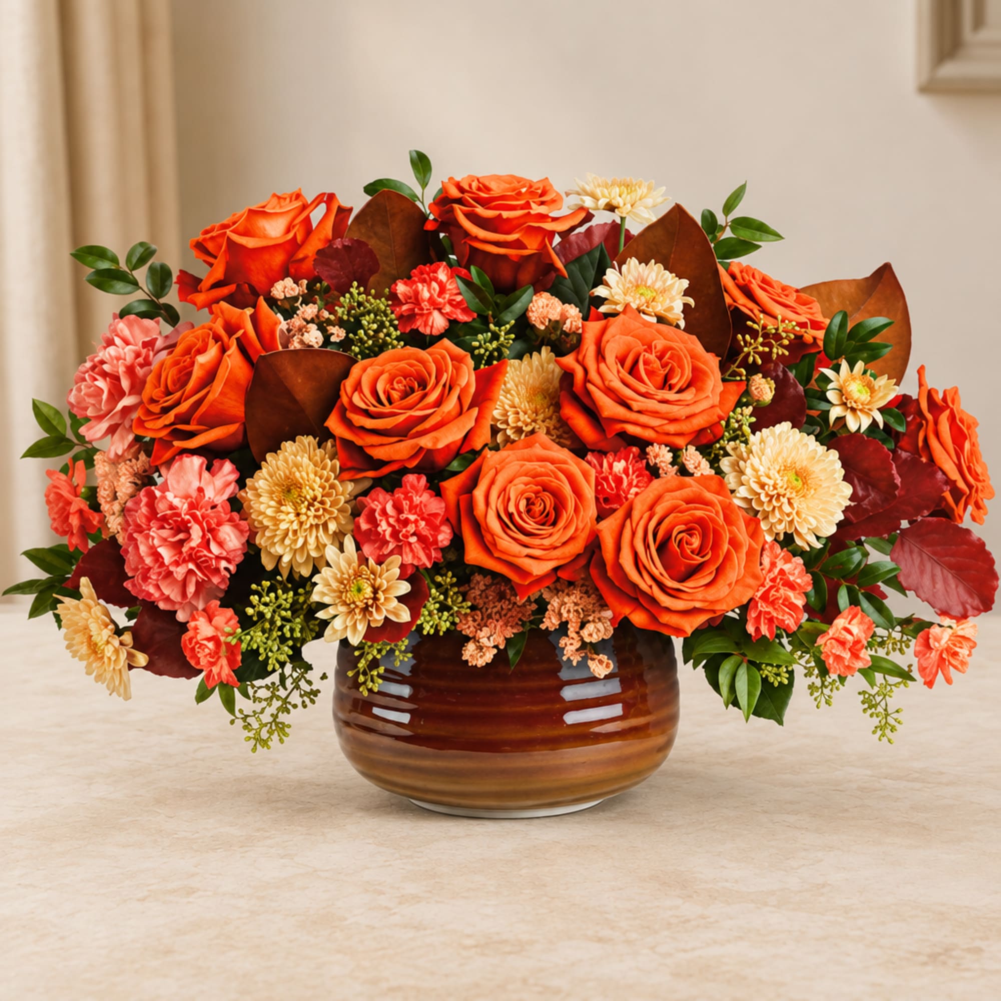 Orange roses and peach flowers arranged in a brown vase