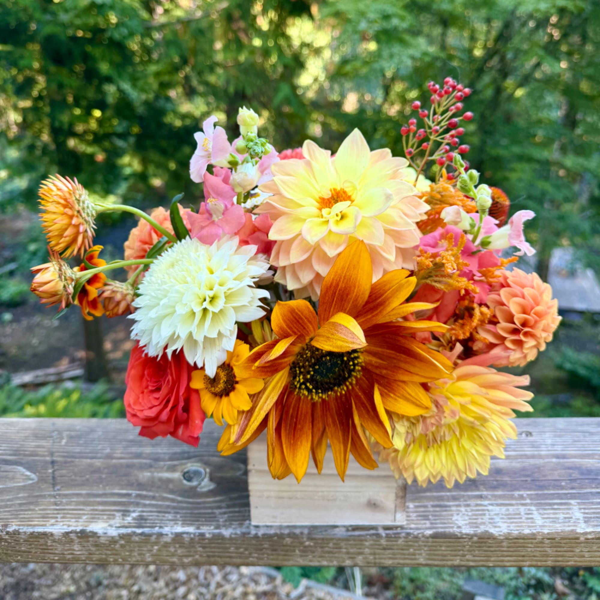 Mixed bouquet of orange, yellow, pink, and white flowers in a wooden box, photo 2 of 3