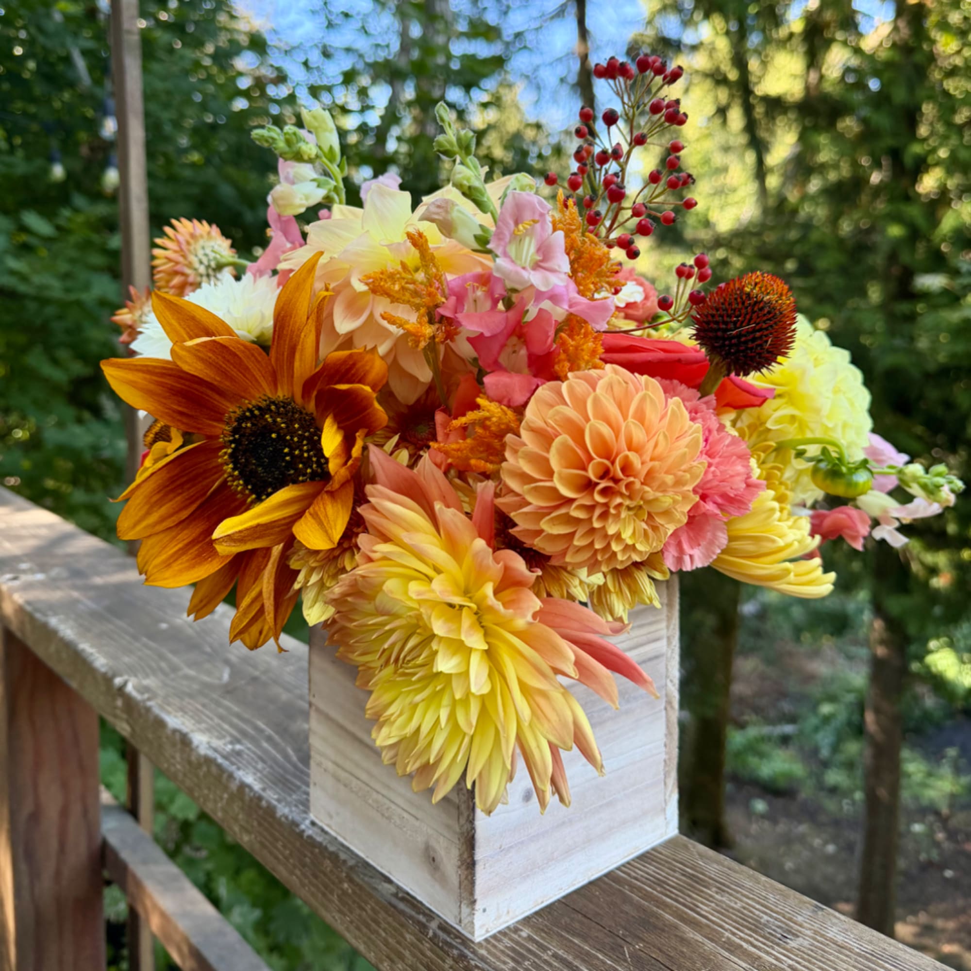 Mixed bouquet in a white wooden box with sunflowers and dahlias