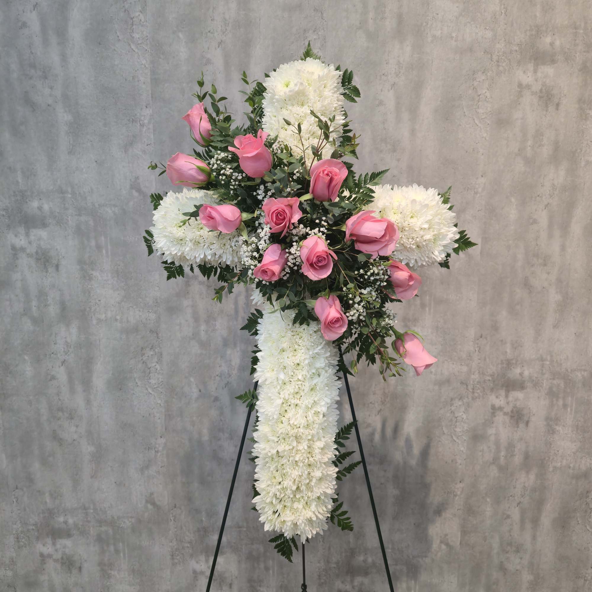 A formal standing tribute crafted in a classic cross shape, this White