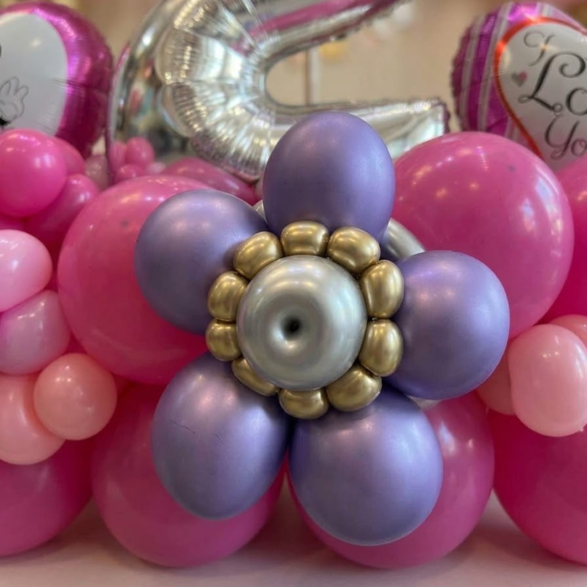 Pink and lavender balloon flower with silver and gold balloons