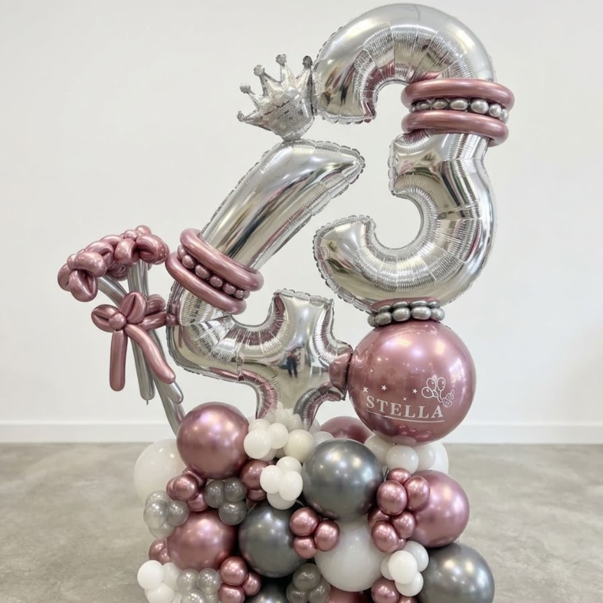 Silver and pink balloon arrangement with a large number 35 and a crown topper