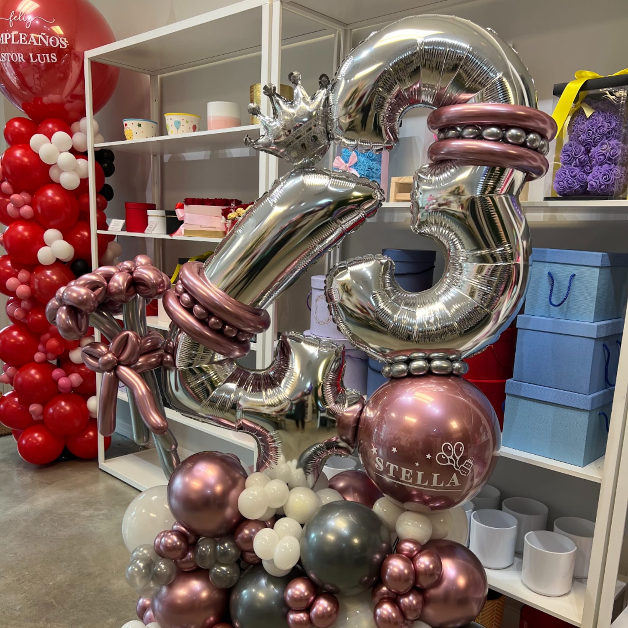 Large balloon display with silver number balloons and pink metallic accents