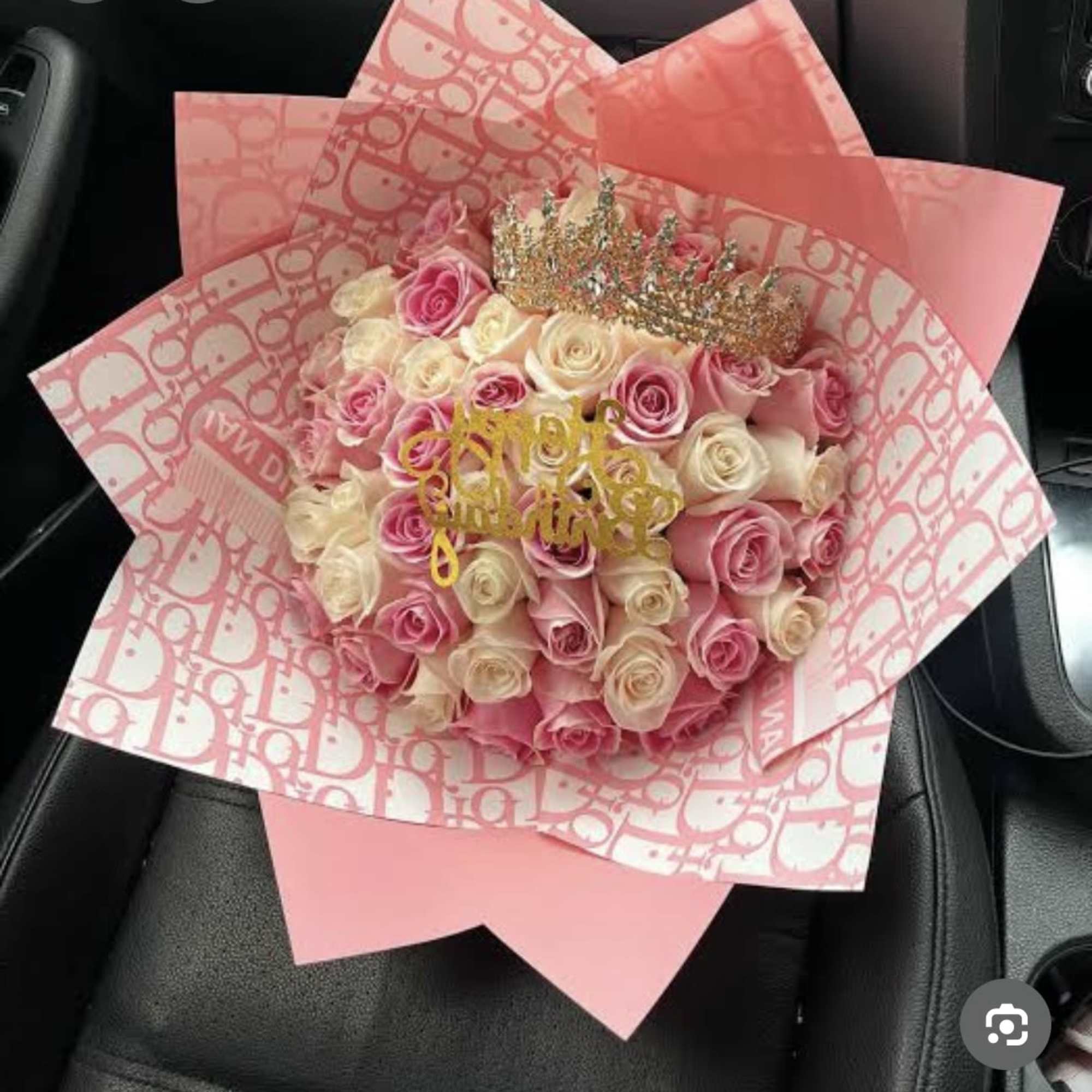 Pink and cream rose bouquet wrapped in patterned pink paper