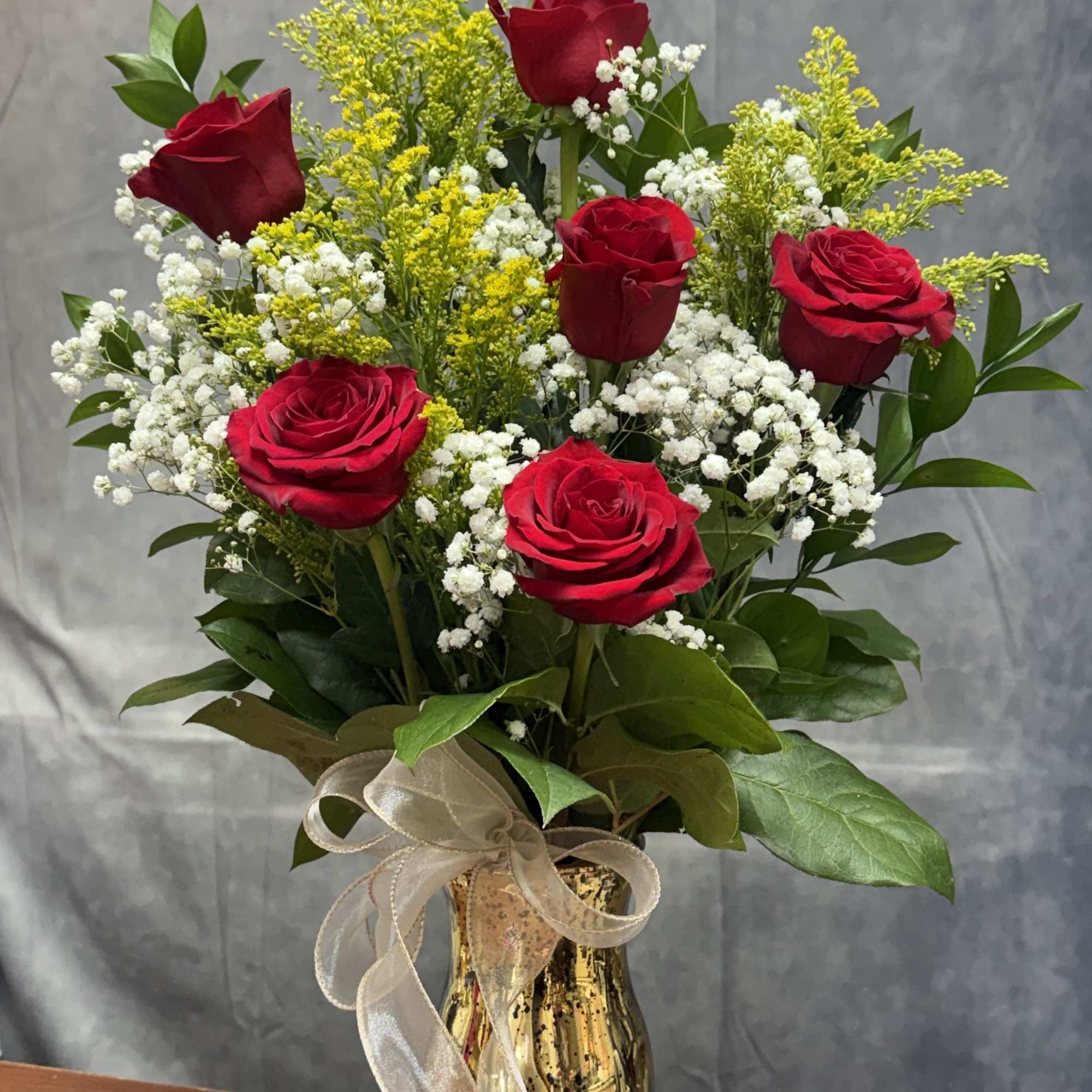 A charming mixed-rose arrangement featuring red roses accented with fresh greenery and, photo 2 of 2