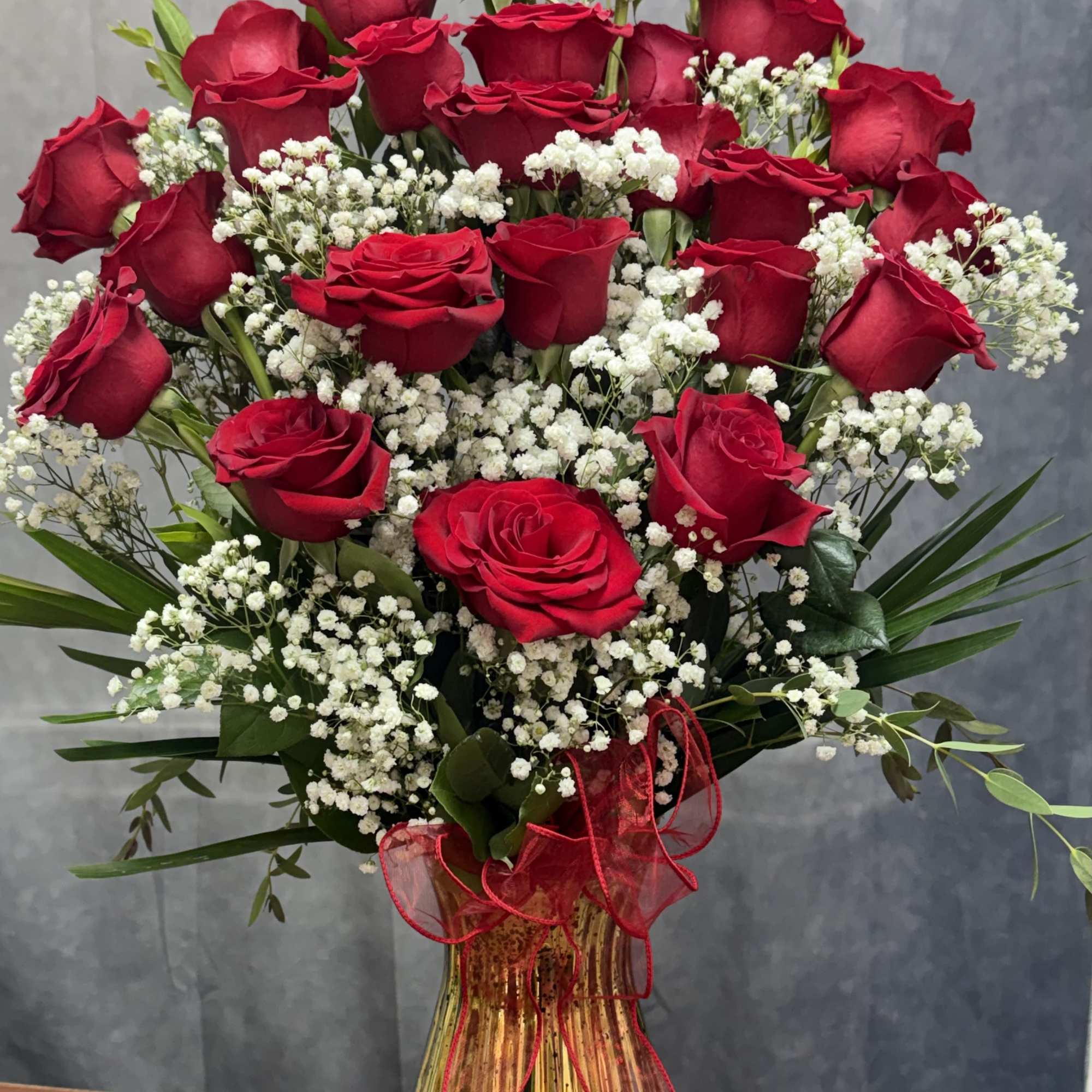 A charming mixed-rose arrangement featuring red roses accented with fresh greenery and, photo 2 of 2