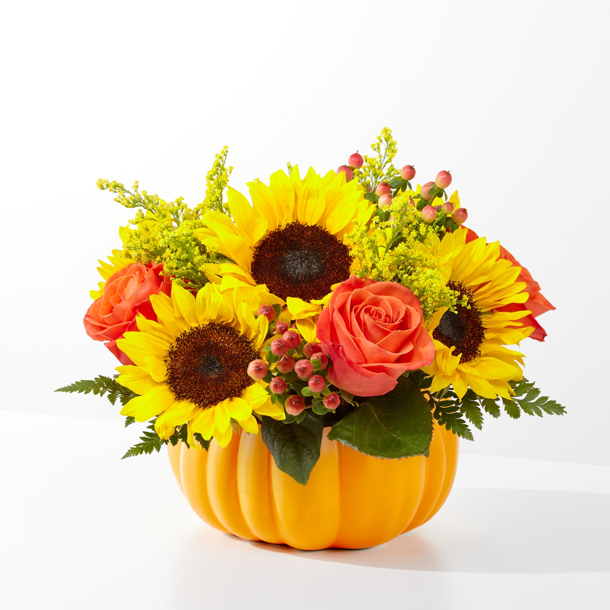 Traditional fall flowers in a ceramic pumpkin.  Great fall arrangement for
