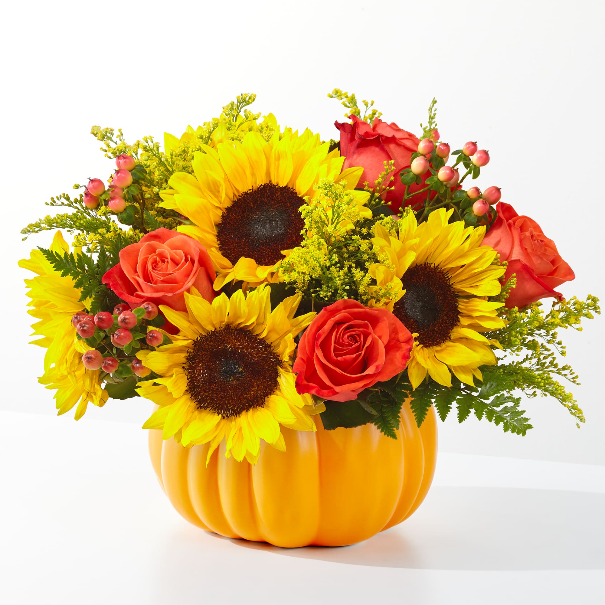 Traditional fall flowers in a ceramic pumpkin.  Great fall arrangement for