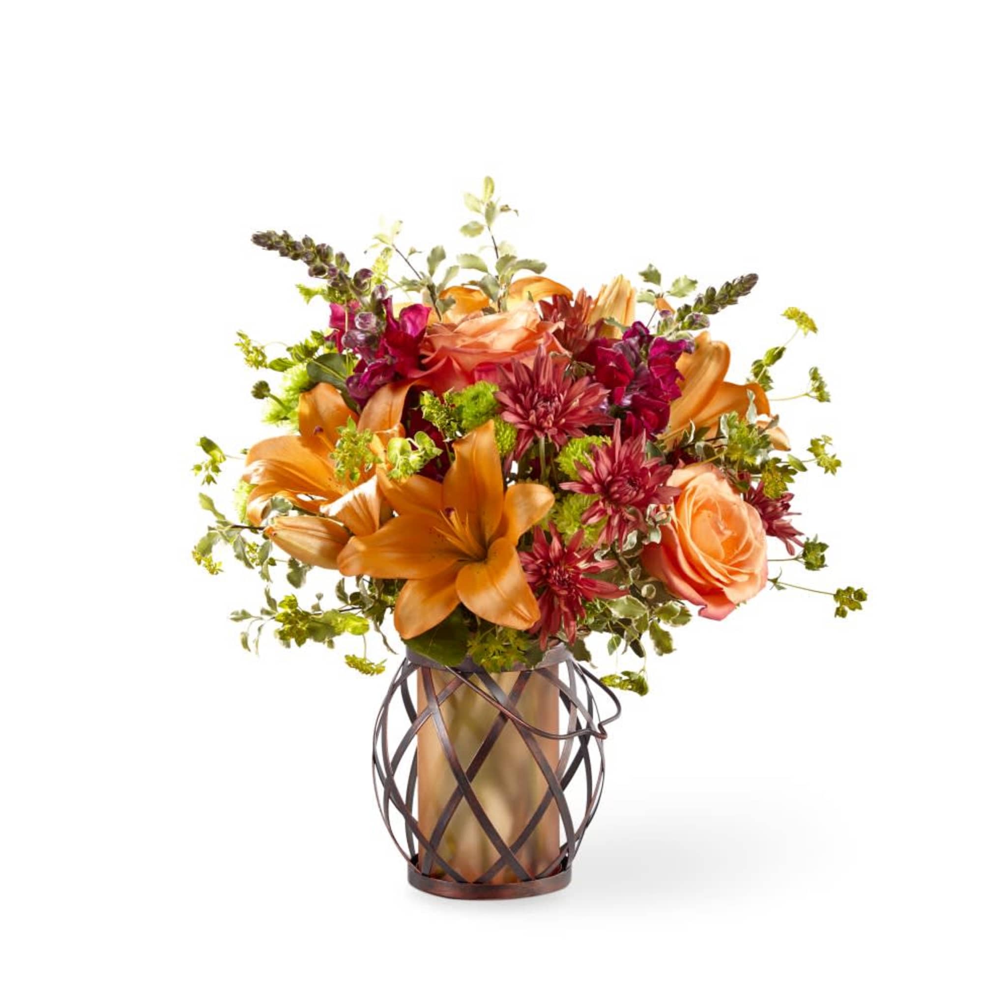 Roses, snapdragons, and lilies fill a lovely keepsake lantern or similar keepsake