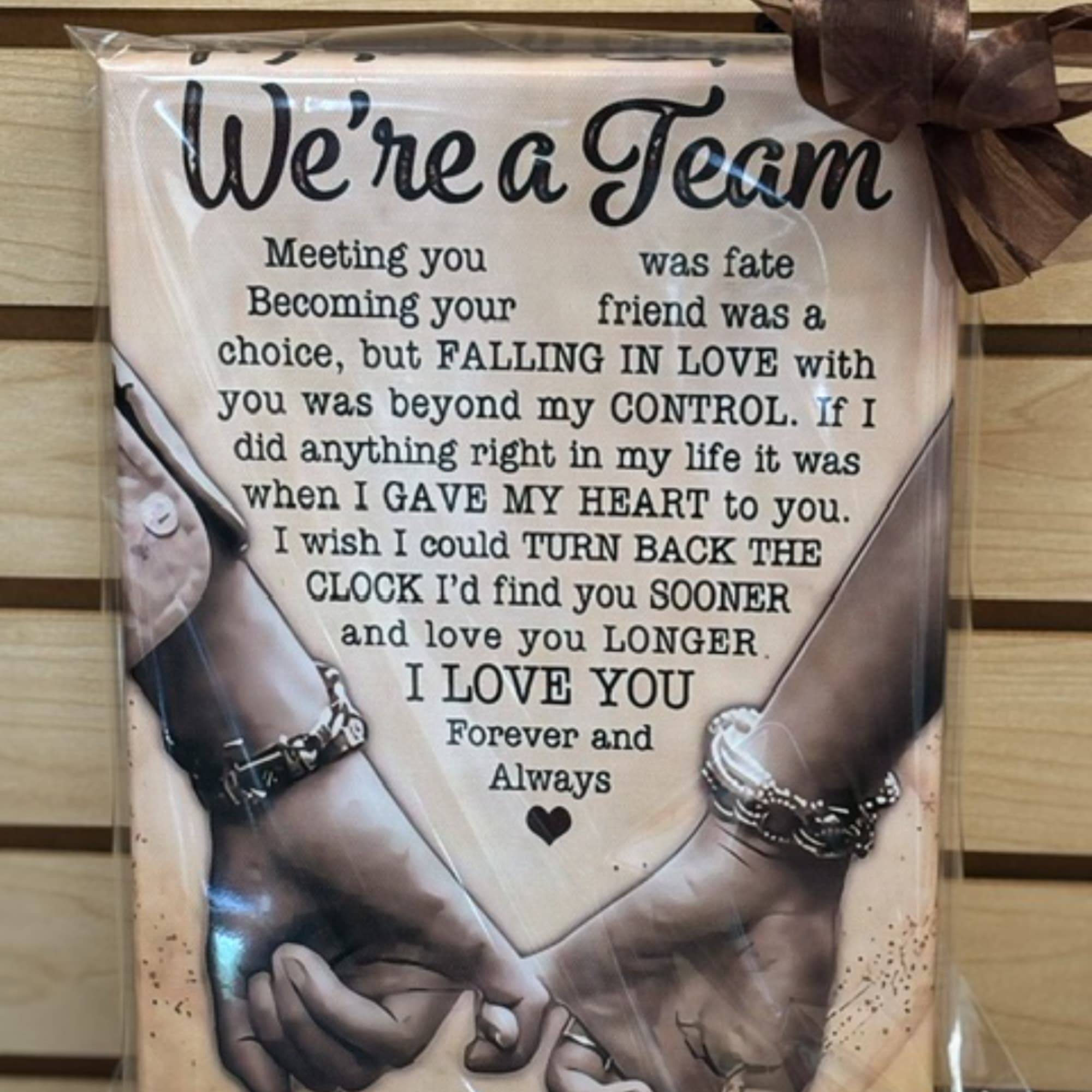 Framed romantic sign with a love quote and two hands holding