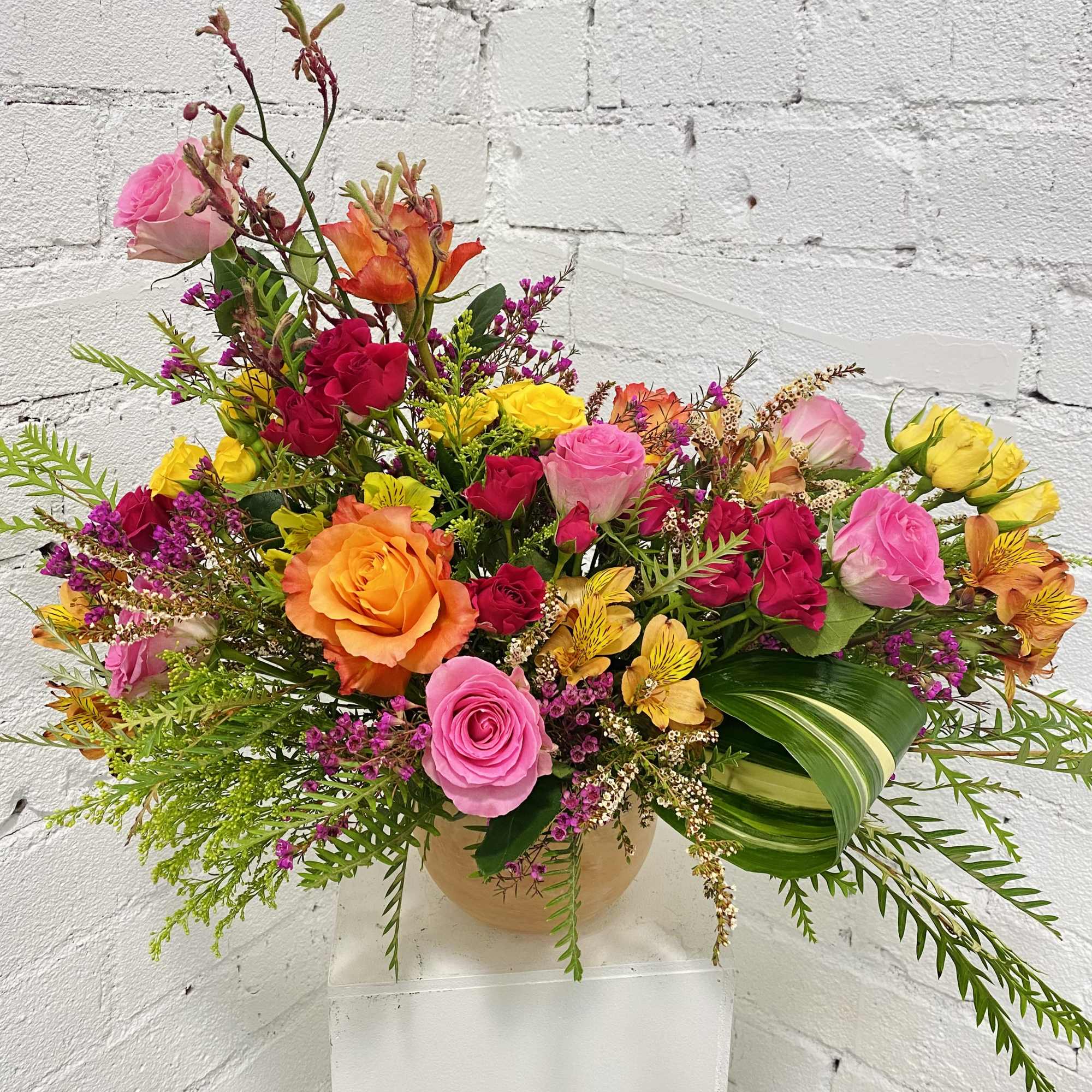 Colorful mixed bouquet of roses and alstroemeria in a vase